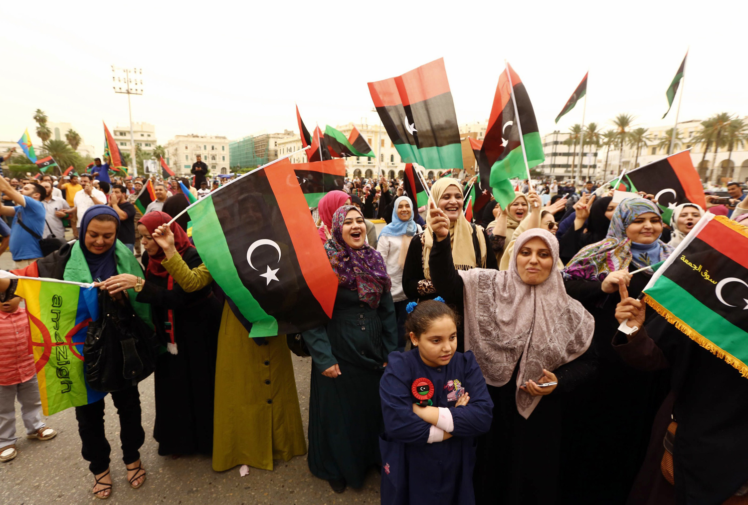 Libyans wave the national flag as they gather at Martyrs' Square to celebrate the decision of Libya's supreme court, in Tripoli on November 6, 2014. (Mahmud Turkia — AFP/Getty Images)
