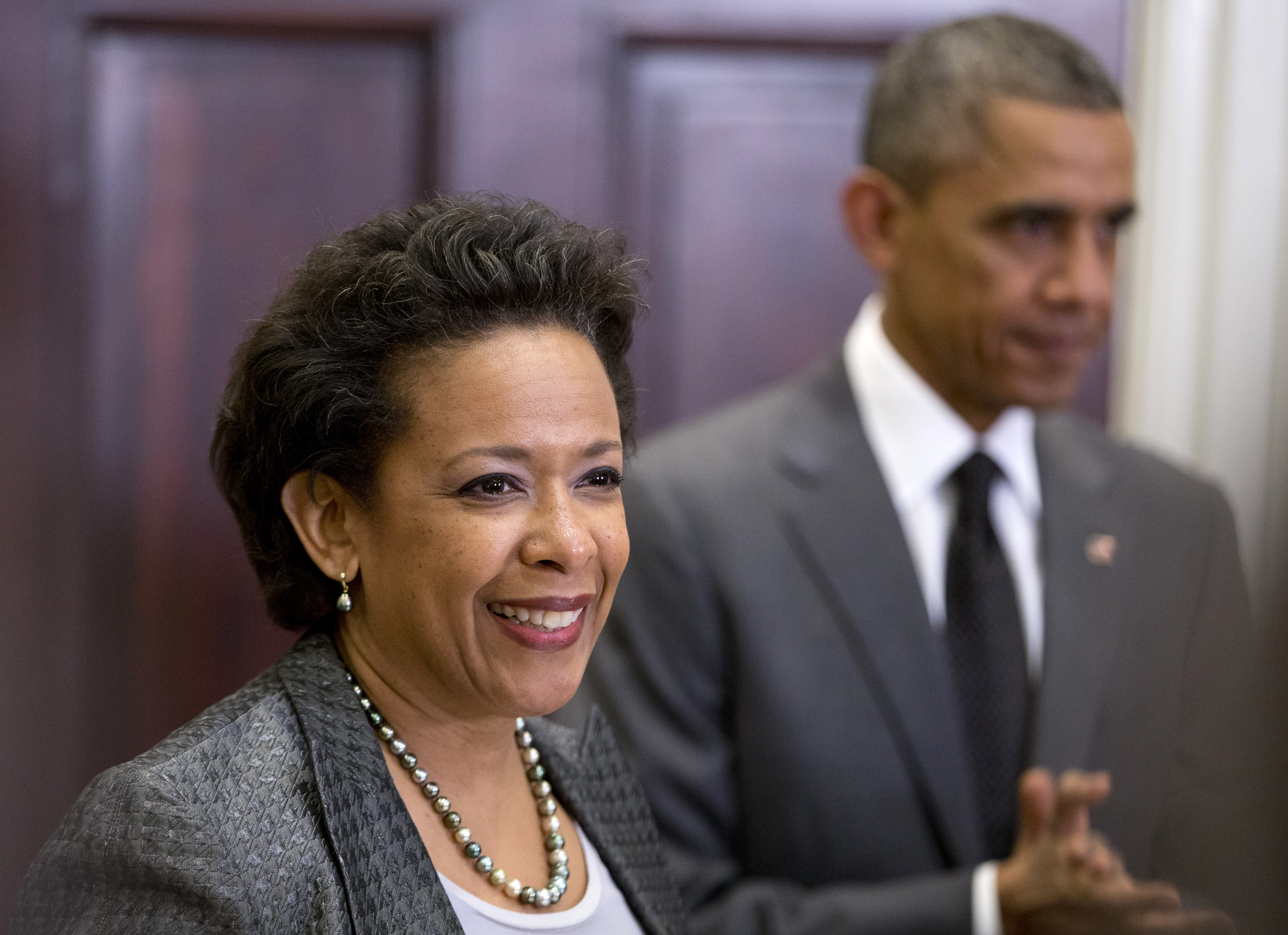 President Barack Obama listens at right as US Attorney Loretta Lynch speaks in the Roosevelt Room of the White House in Washington on Nov. 8, 2014.