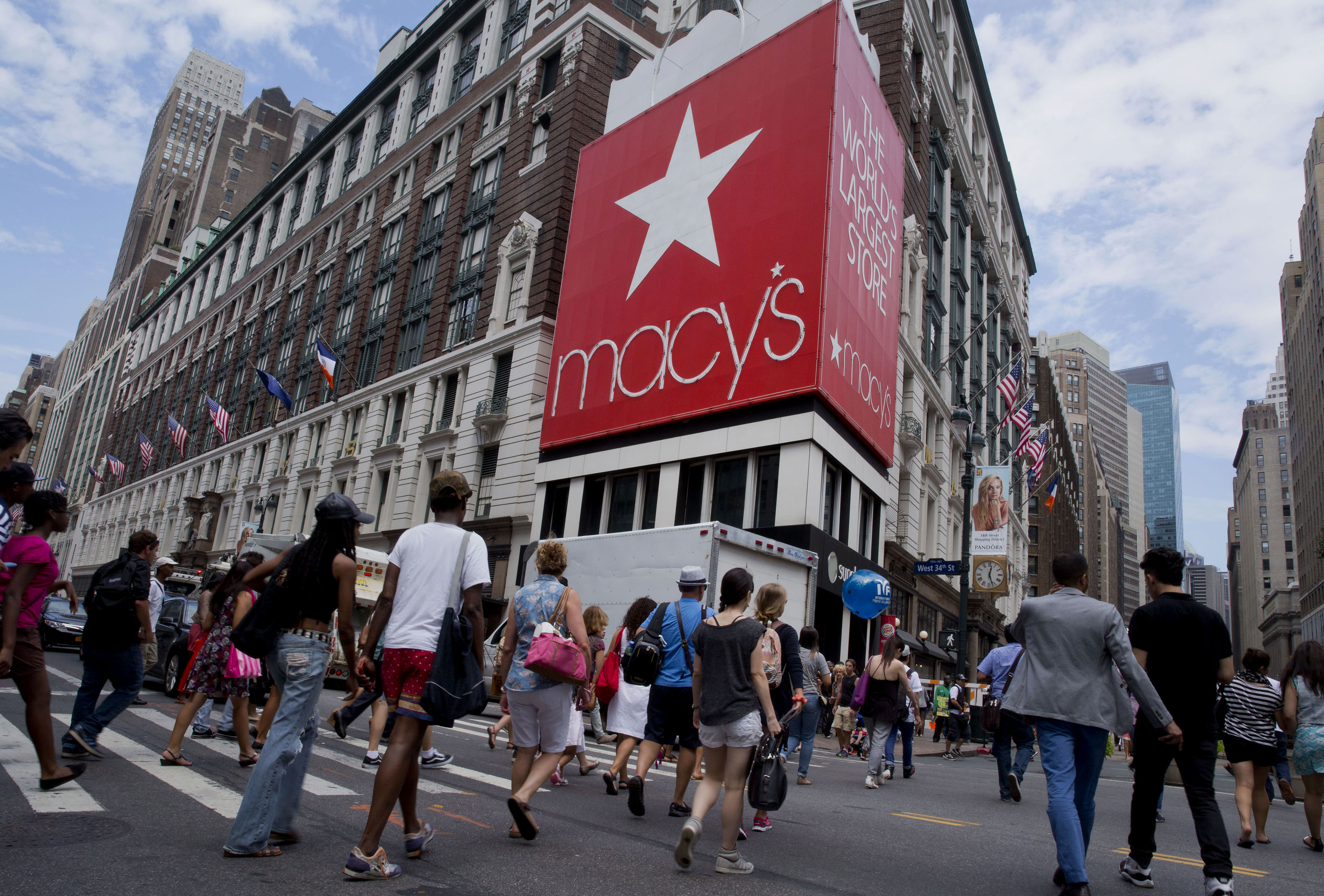 Pedestrians cross the street in front of the Macy's Inc. flagship store in New York City on Aug. 6, 2014. (Bloomberg—Bloomberg via Getty Images)