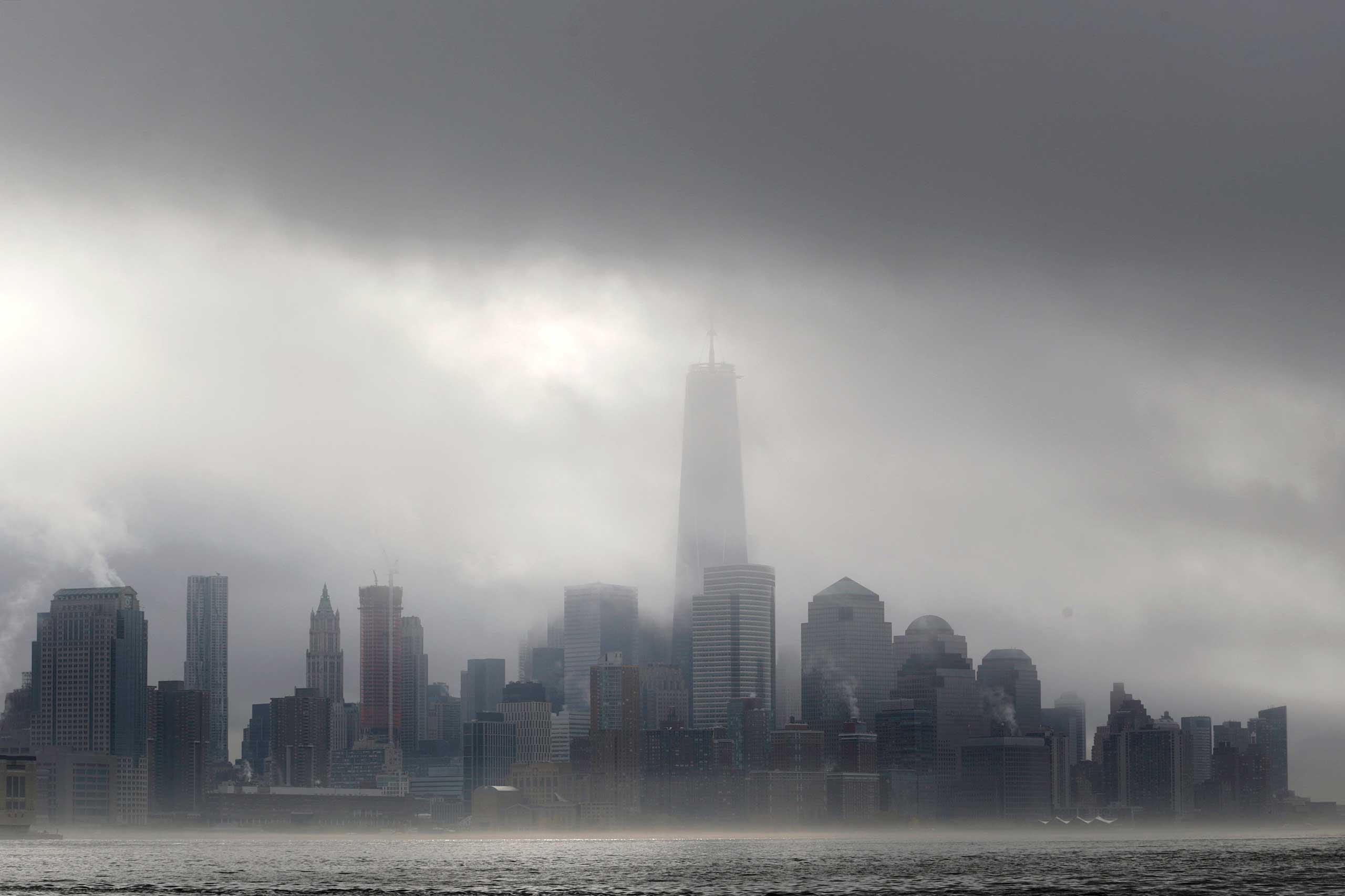 Heavy fog blankets lower Manhattan in New York, including One World Trade Center, center, in this view across the Hudson River from Hoboken, N.J., Nov. 12, 2014. (Julio Cortez—AP)