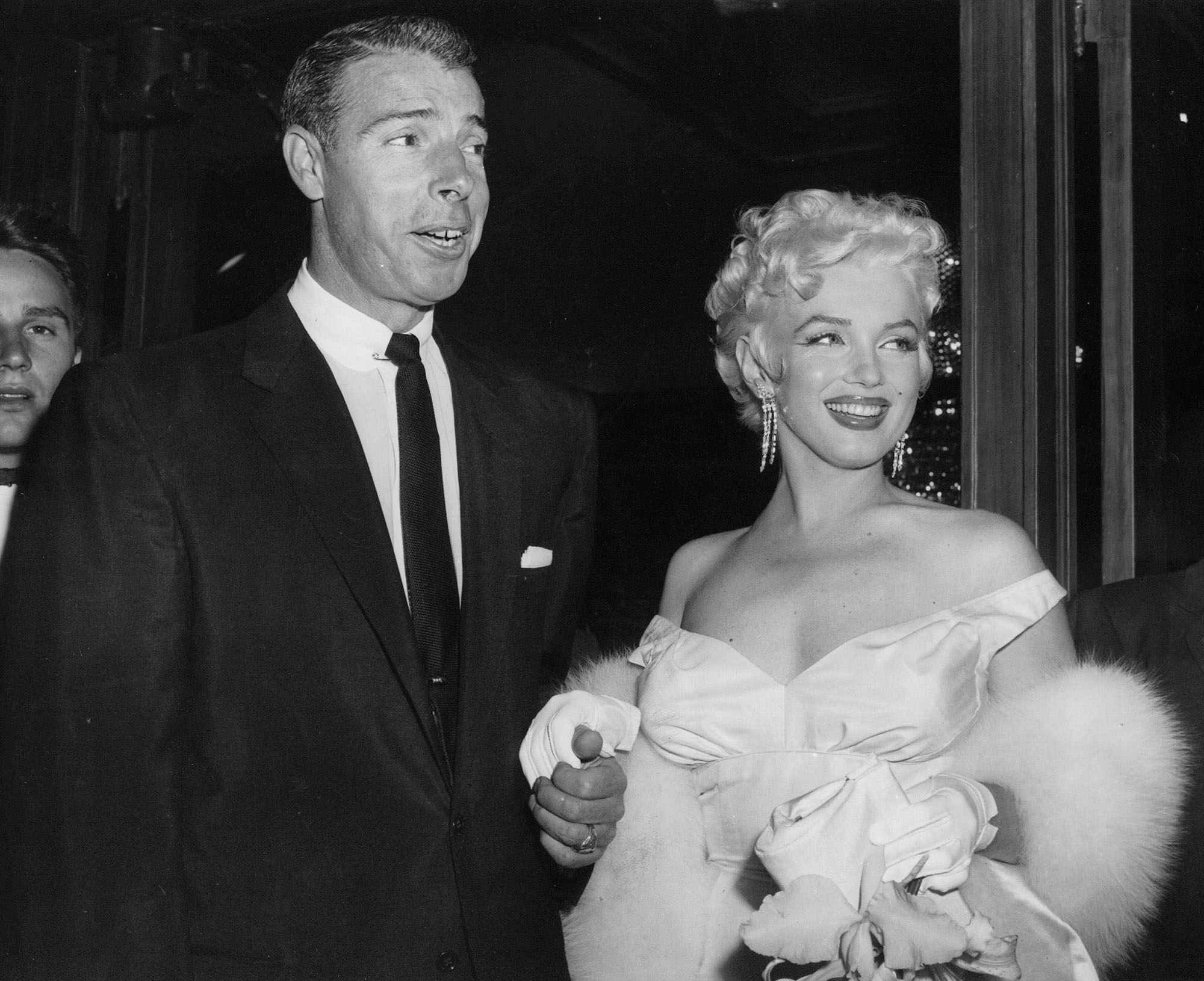 In this June 2, 1955 file photo, actress Marilyn Monroe, right, dressed in a glamorous evening gown, arrives with Joe DiMaggio at the theater. (Associated Press)