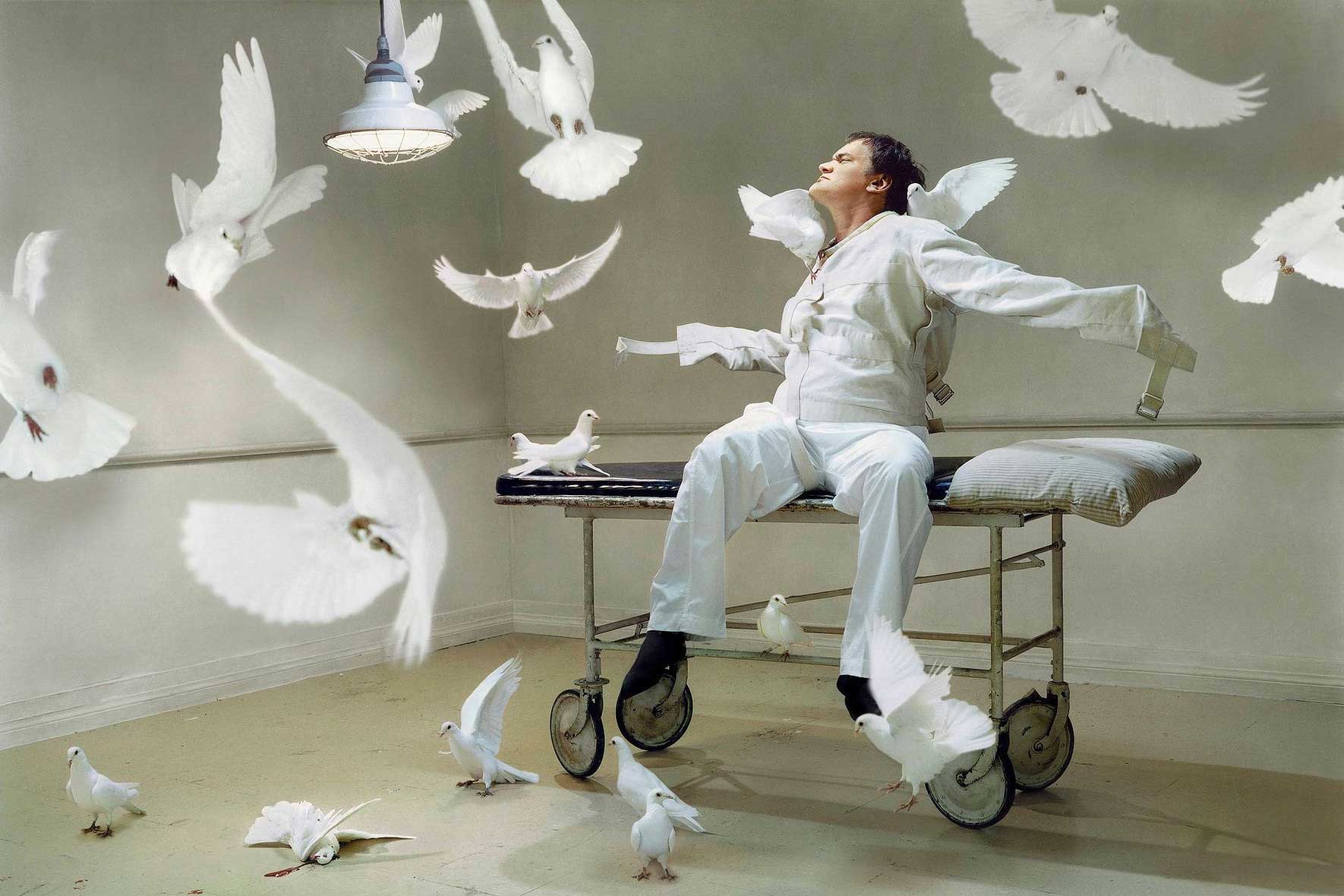 Quentin Tarantino."This was during the days of Kill Bill. I thought of a shoot with white doves. Sort of him being the victim of these white doves -- a [symbolic] mixture of One Flew Over the Cuckoos Nest, and the symbol of peace. We had the doves and the gurney and it took a while to talk him into it. There were dove wranglers and [the doves] would fly around and come back. Not all the doves are in this frame, though. There is one dead one which makes the whole thing slightly more sinister."