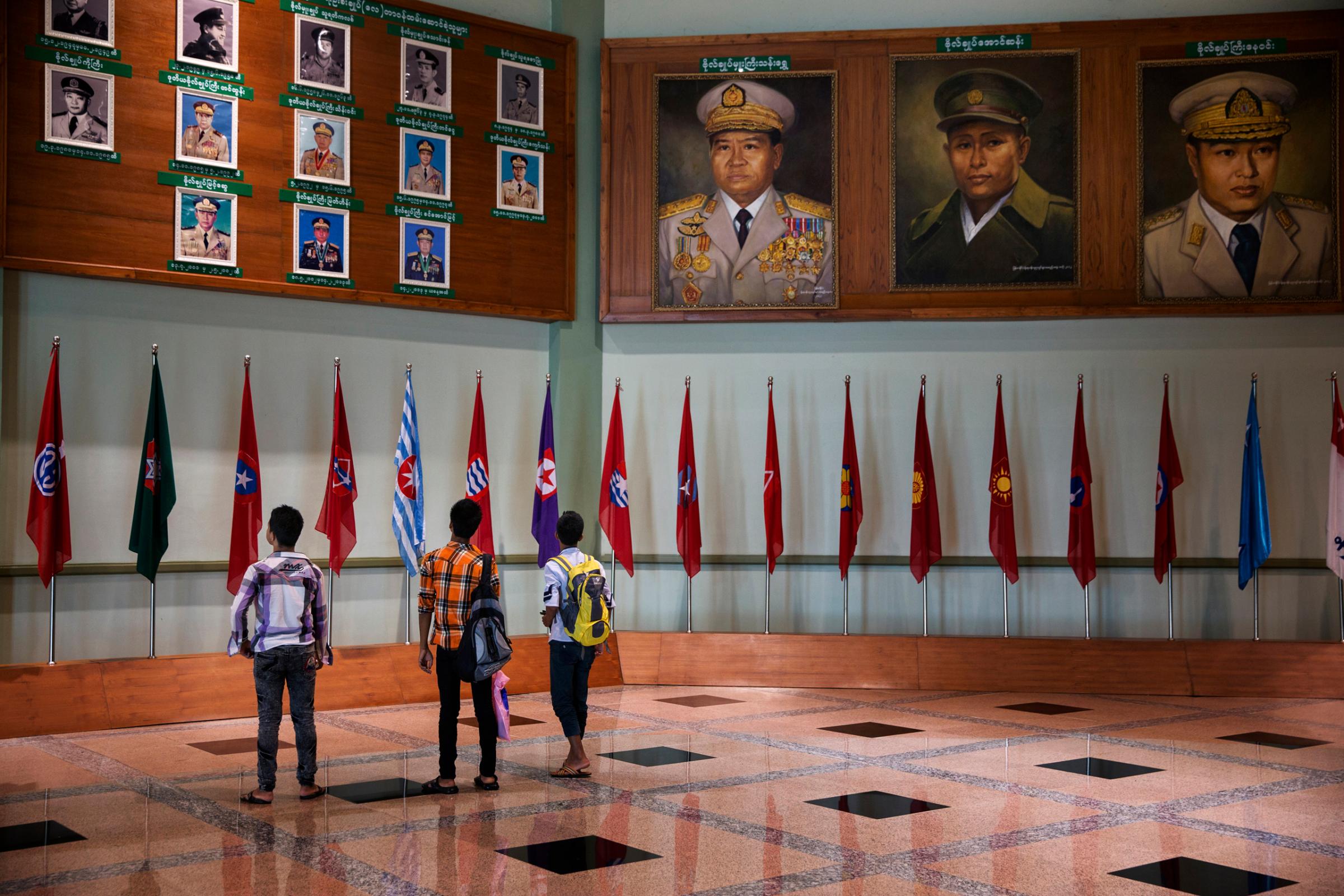 Students visit the Military Museum where  paintings of military leaders hang in Naypyidaw, Burma, Sept. 19, 2014.