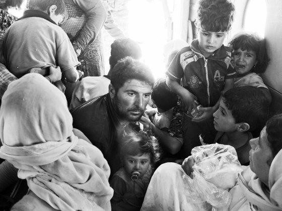 Frightened Yezidi families aboard an Iraqi air force rescue helicopter. Sinjar Mountains, Iraq. Aug. 12, 2014.
