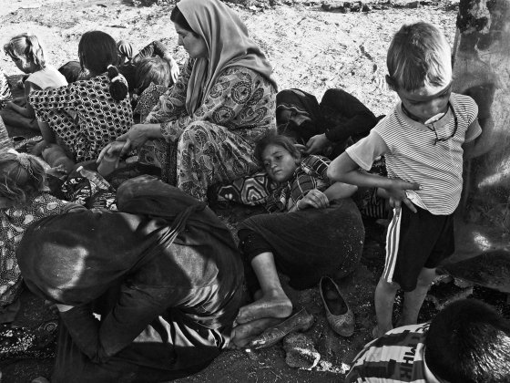 Yezidi women and children from Sinjar, Iraq, rest at a makeshift camp on the outskirts of Derek, a Kurdish-controlled town in Syria that is located at the foot of the Sinjar Mountains. Derek, Syria. Aug. 10, 2014.