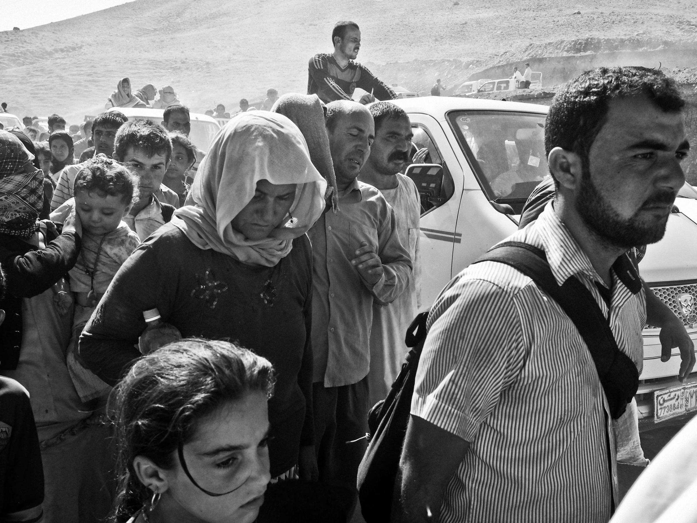 Yezidi families from Sinjar arrive at the Fishkhabur border crossing between Iraq's Dohuk Province and Syria. Iraq. Aug. 10, 2014.