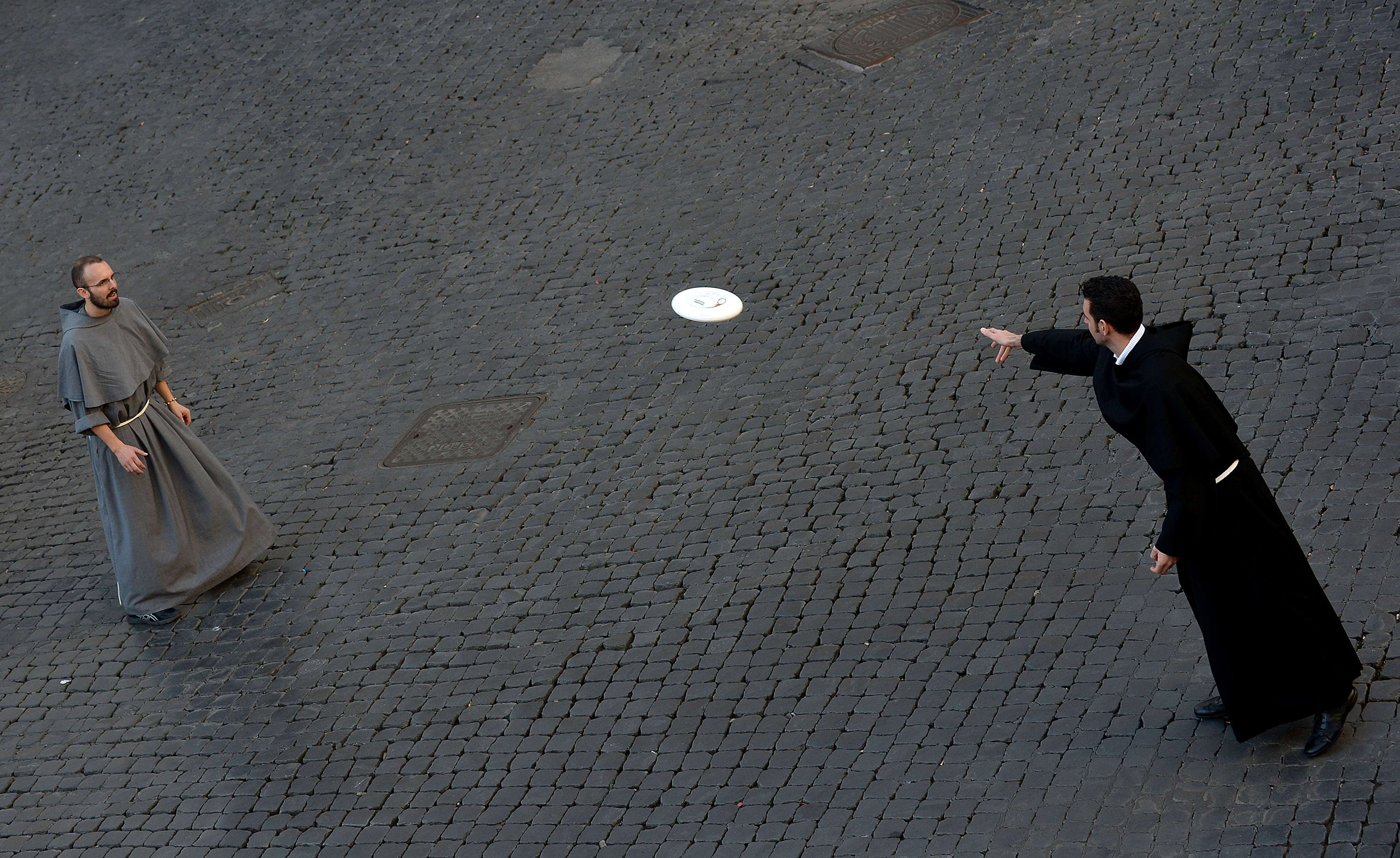 Friars play frisbee at Piazza Santi Apostoli on Nov. 9, 2014 in Rome.
