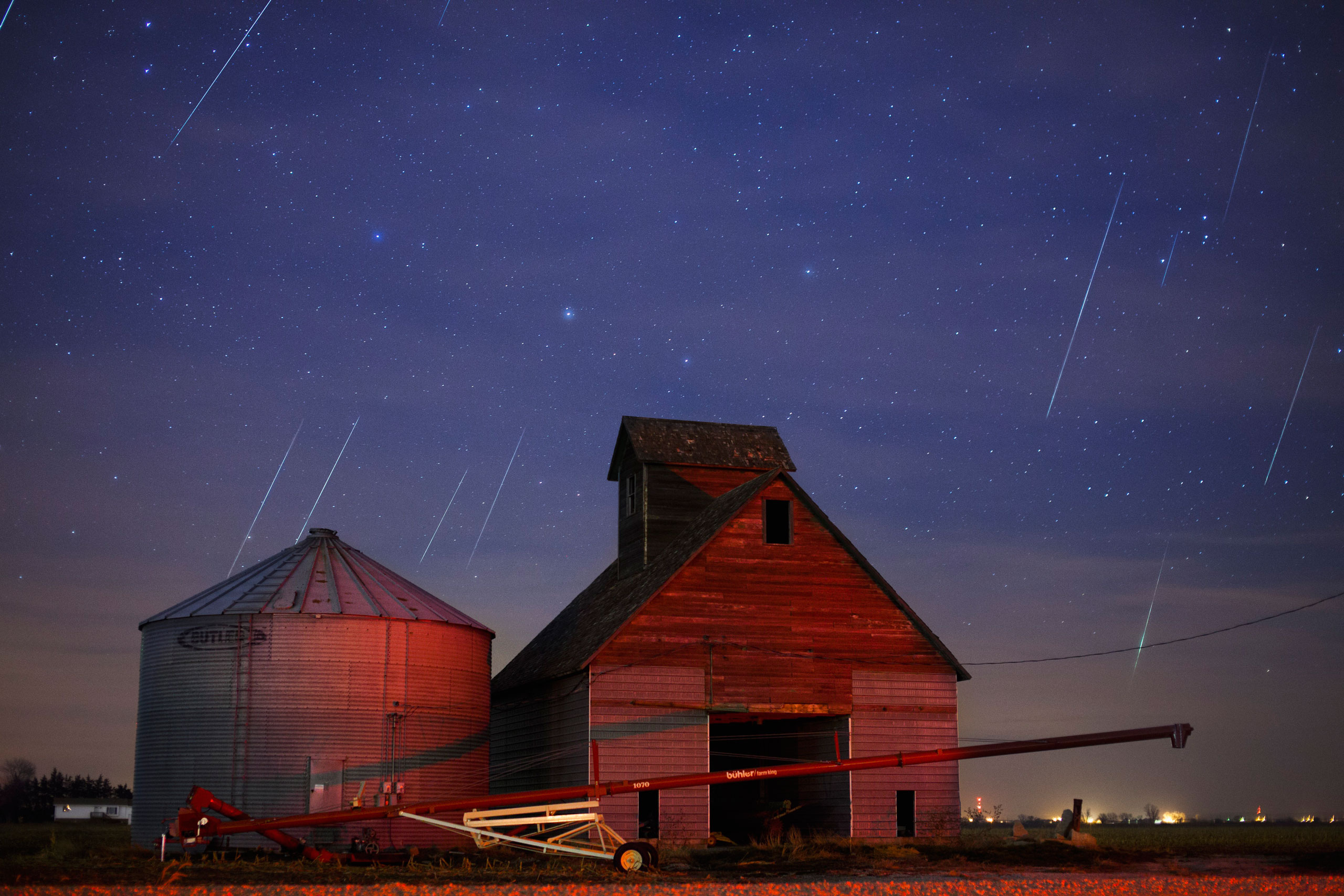 Geminid meteors streak across the sky behind a barn in western Iowa on Dec. 12, 2012.