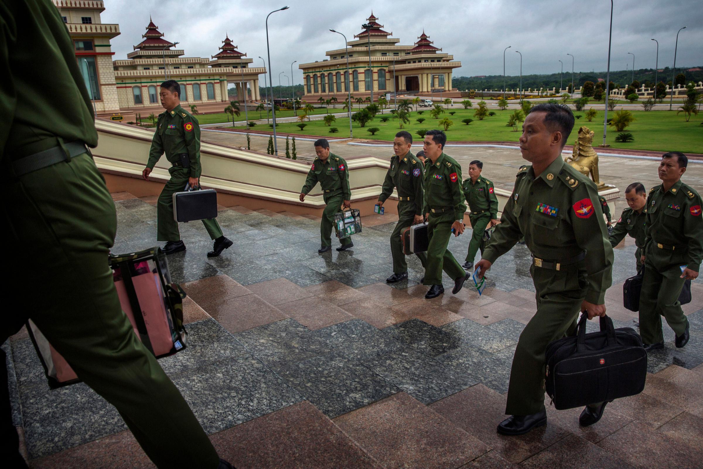 MPs representing the military arrive for a parliamentary session in the Naypyidaw, Burma,  June 20th, 2014.