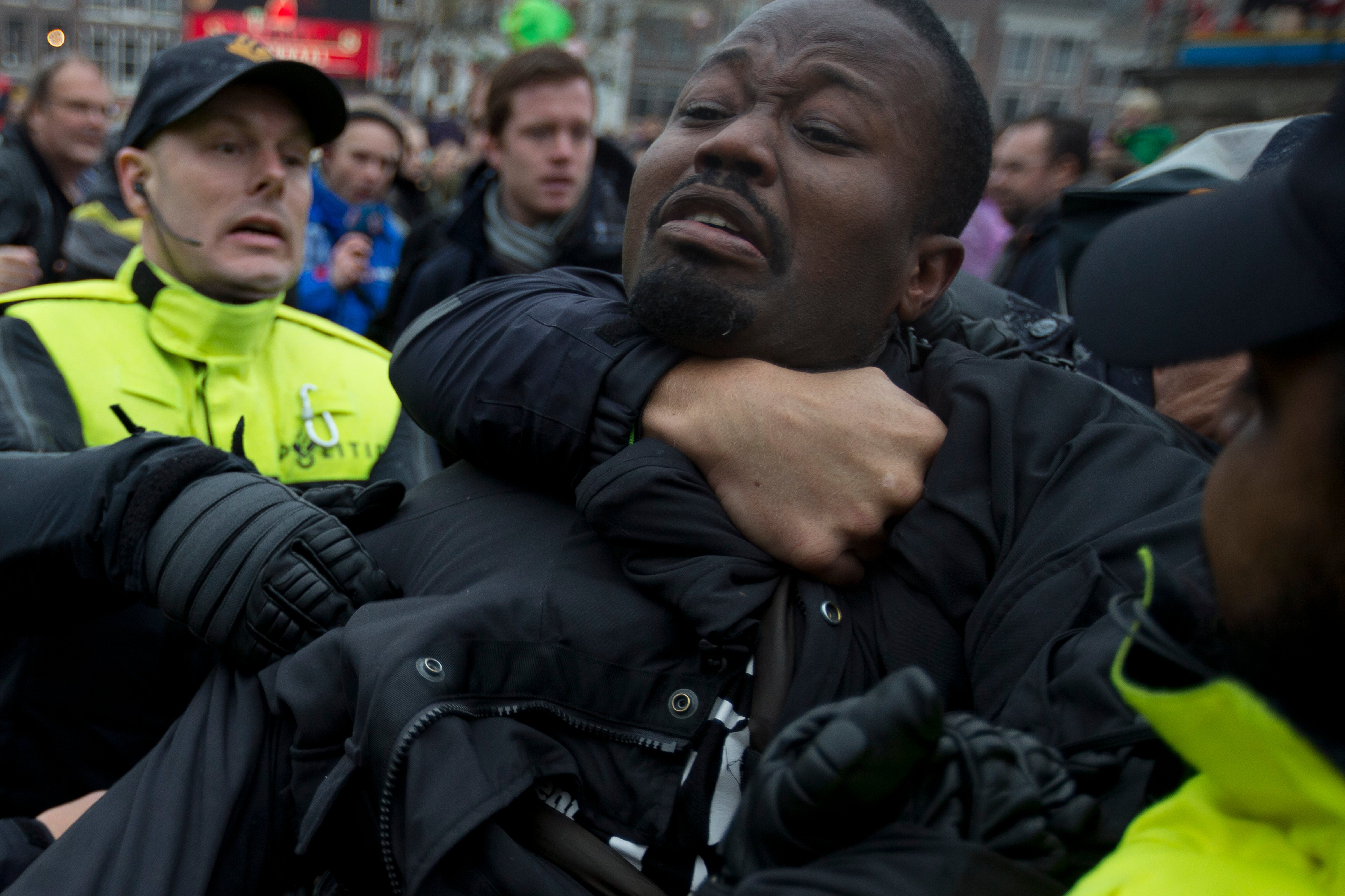 Police detain an anti–Black Pete demonstrator as St. Nicholas arrived in the Dutch city of Gouda on Nov. 15, 2014 (Peter Dejong—AP)