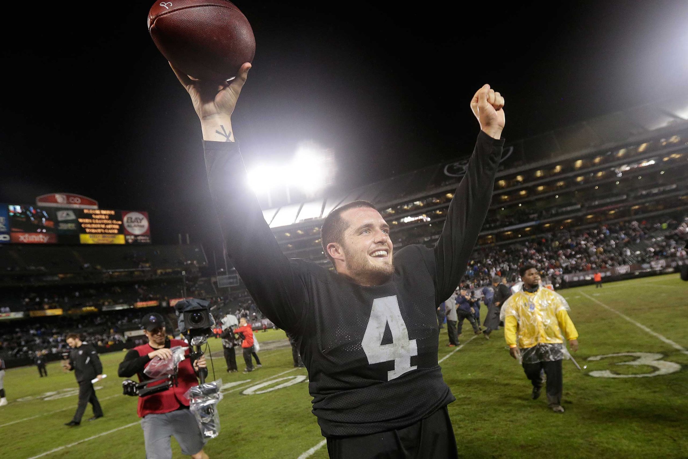 Oakland Raiders quarterback Derek Carr celebrates after the Raiders defeated the Kansas City Chiefs 24-20 in an NFL football game in Oakland, Calif., Nov. 20, 2014.