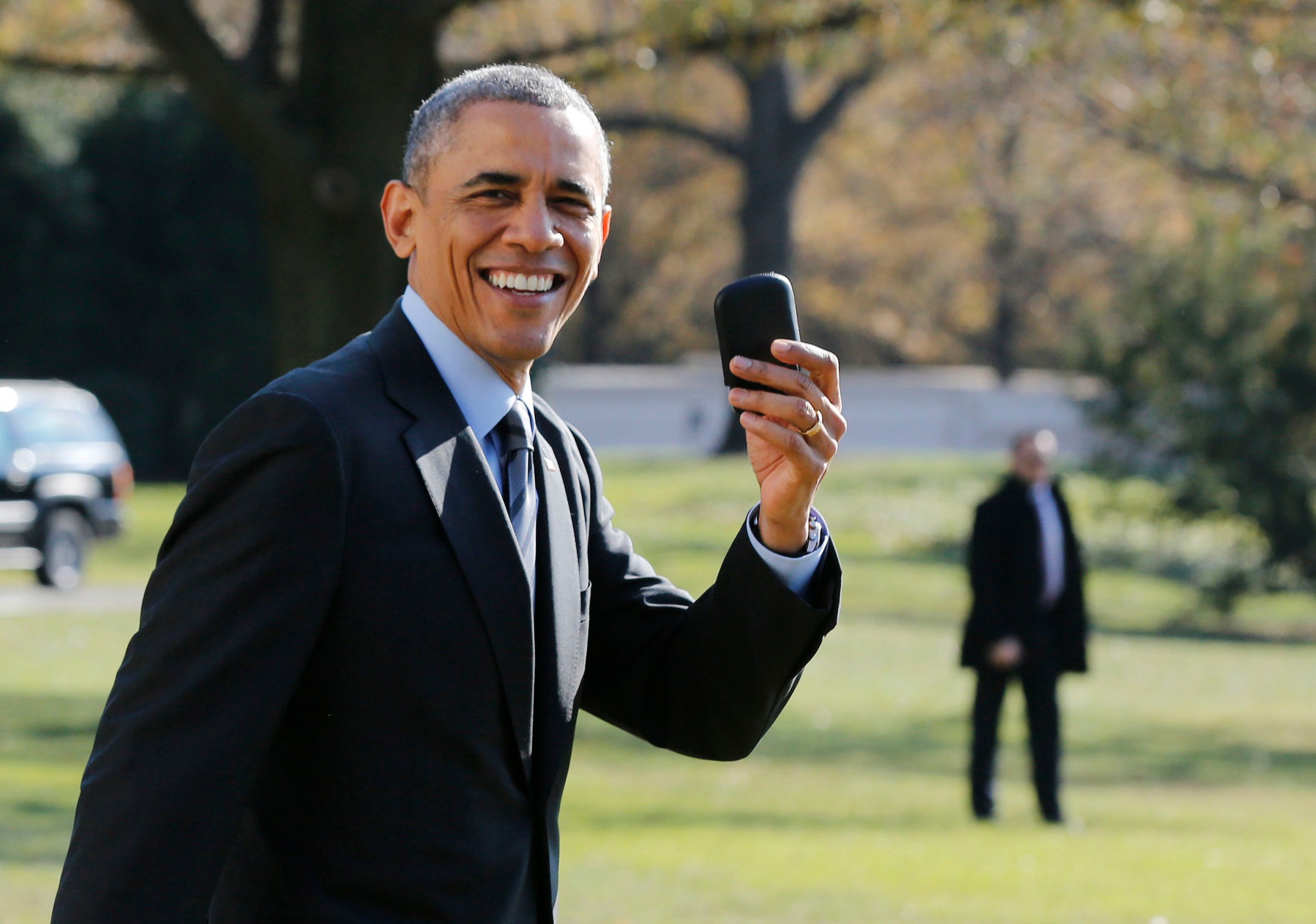 U.S. President Barack Obama holds up his BlackBerry device after he returned inside the White House to retrieve it, after boarding Marine One on the South Lawn of the White House in Washington on Nov. 21, 2014.