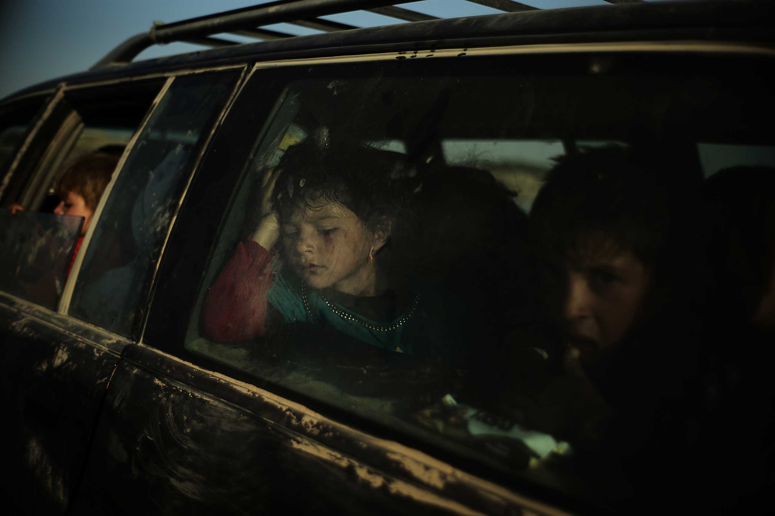 A Yazidi family, from Sinjar, wait to cross the Syrian-Iraqi border after being rescued from Mount Sinjar, Iraq, Aug. 10, 2014.