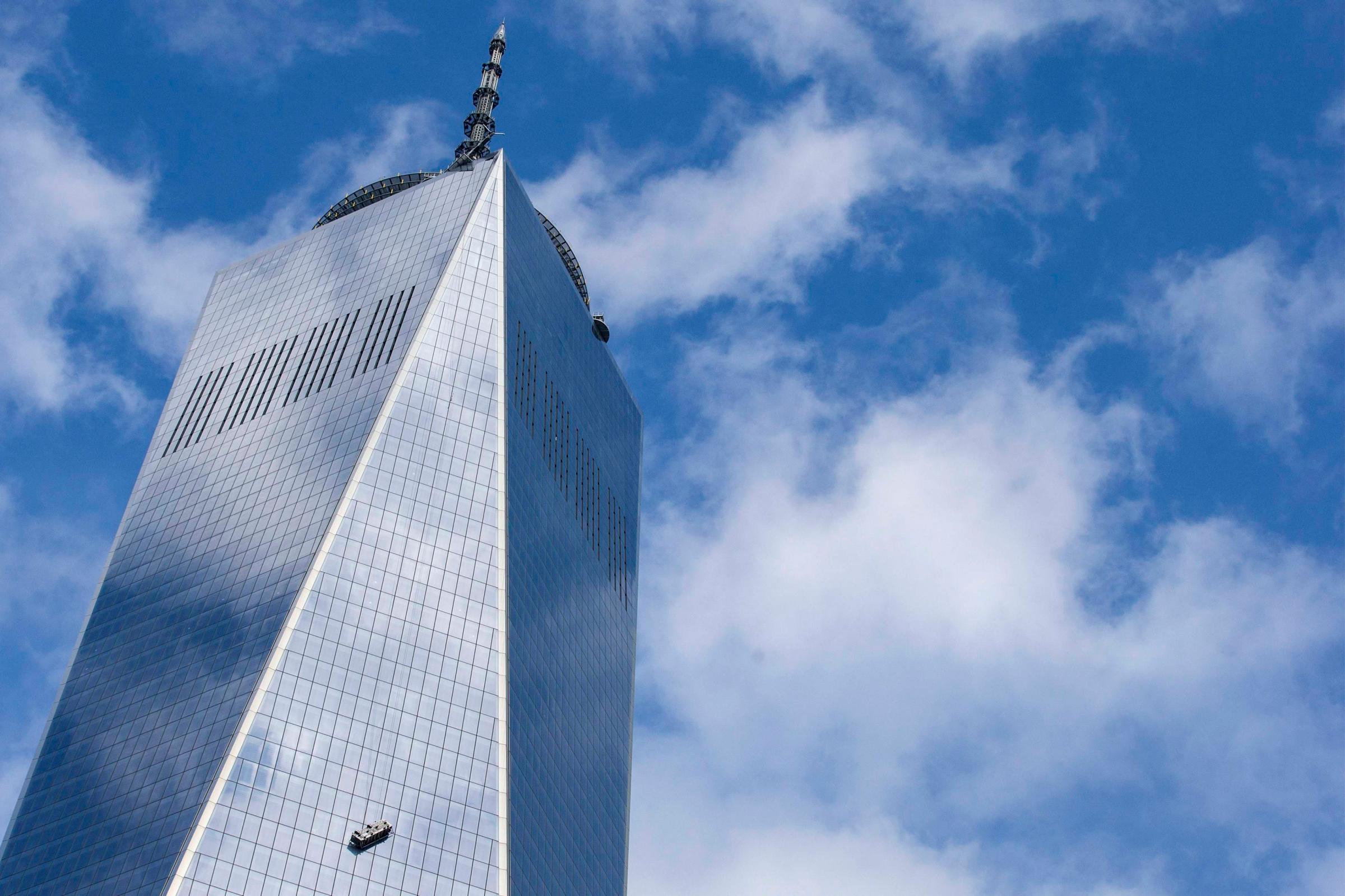 Stranded window washers hang on the side of One World Trade Center