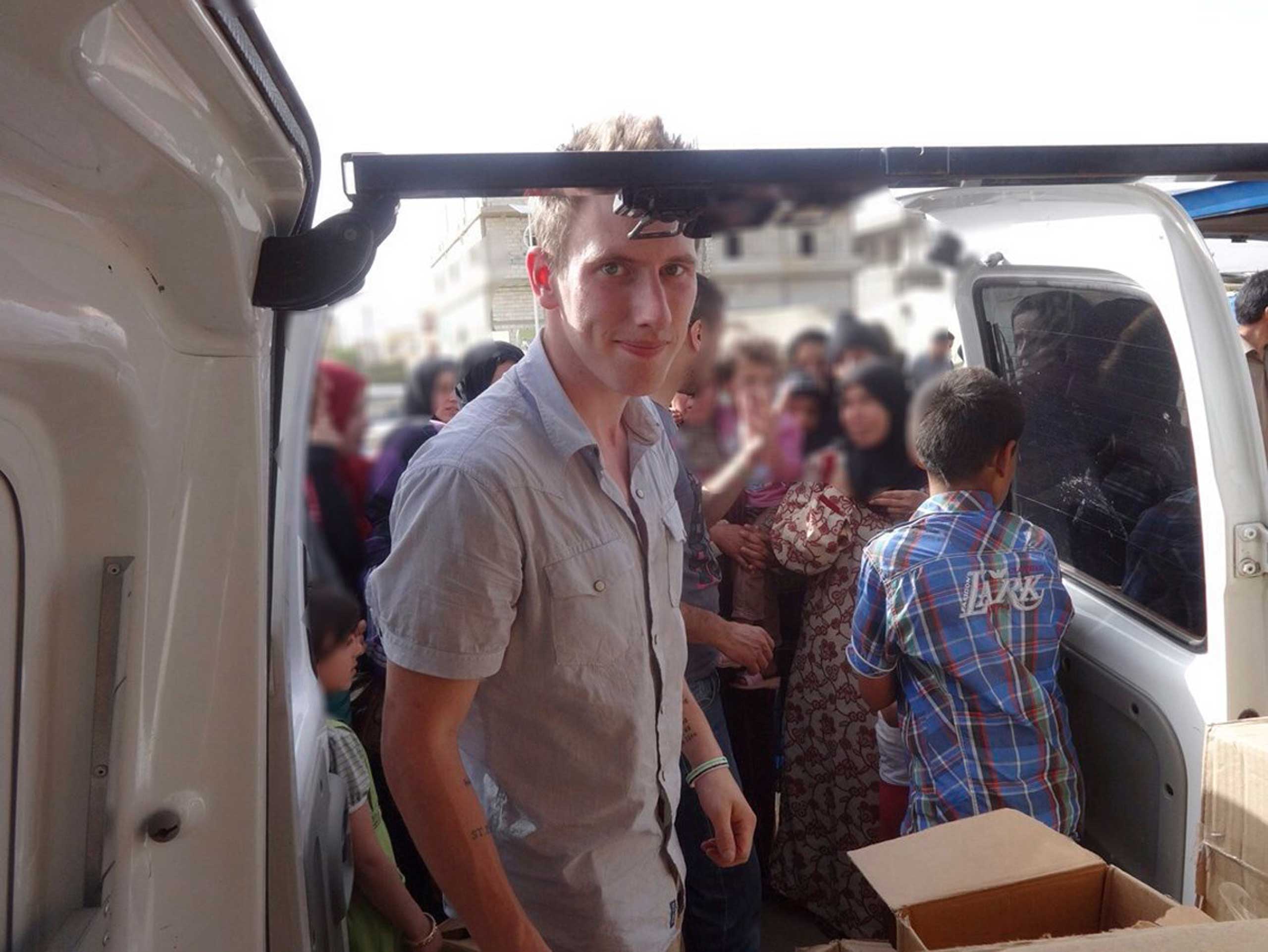 Abdul-Rahman (Peter) Kassig is pictured making a food delivery to refugees in Lebanonís Bekaa Valley in this May 2013 handout photo. (Reuters)