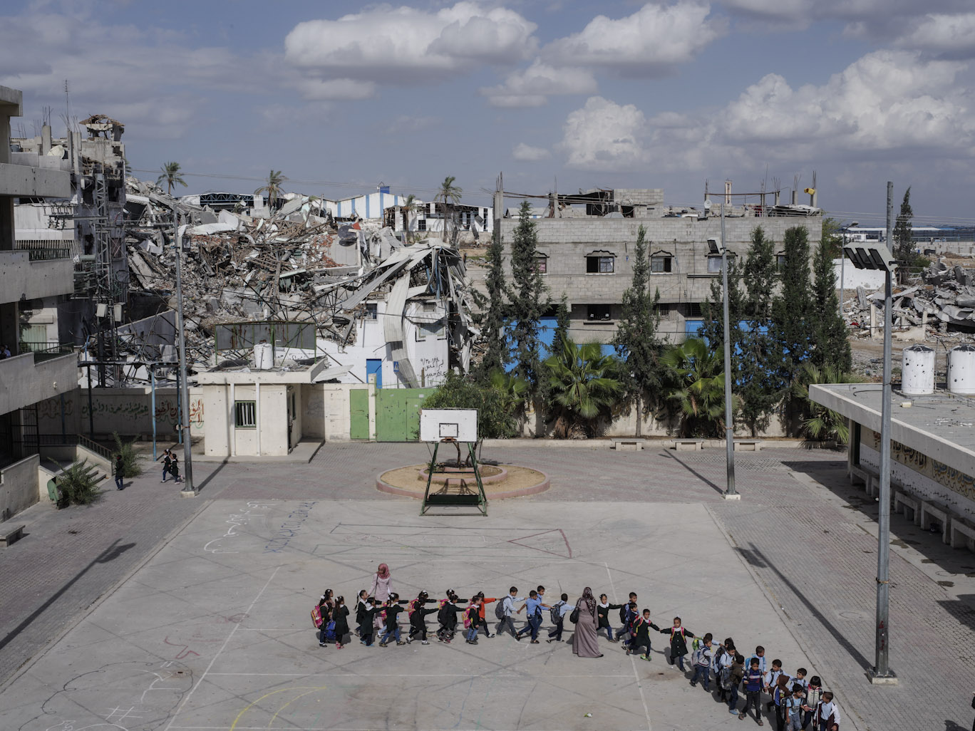 Schoolchildren head to class at the Sobhi Abu Karsh School in the Shujai'iya neighborhood of Gaza, Oct. 20, 2014.