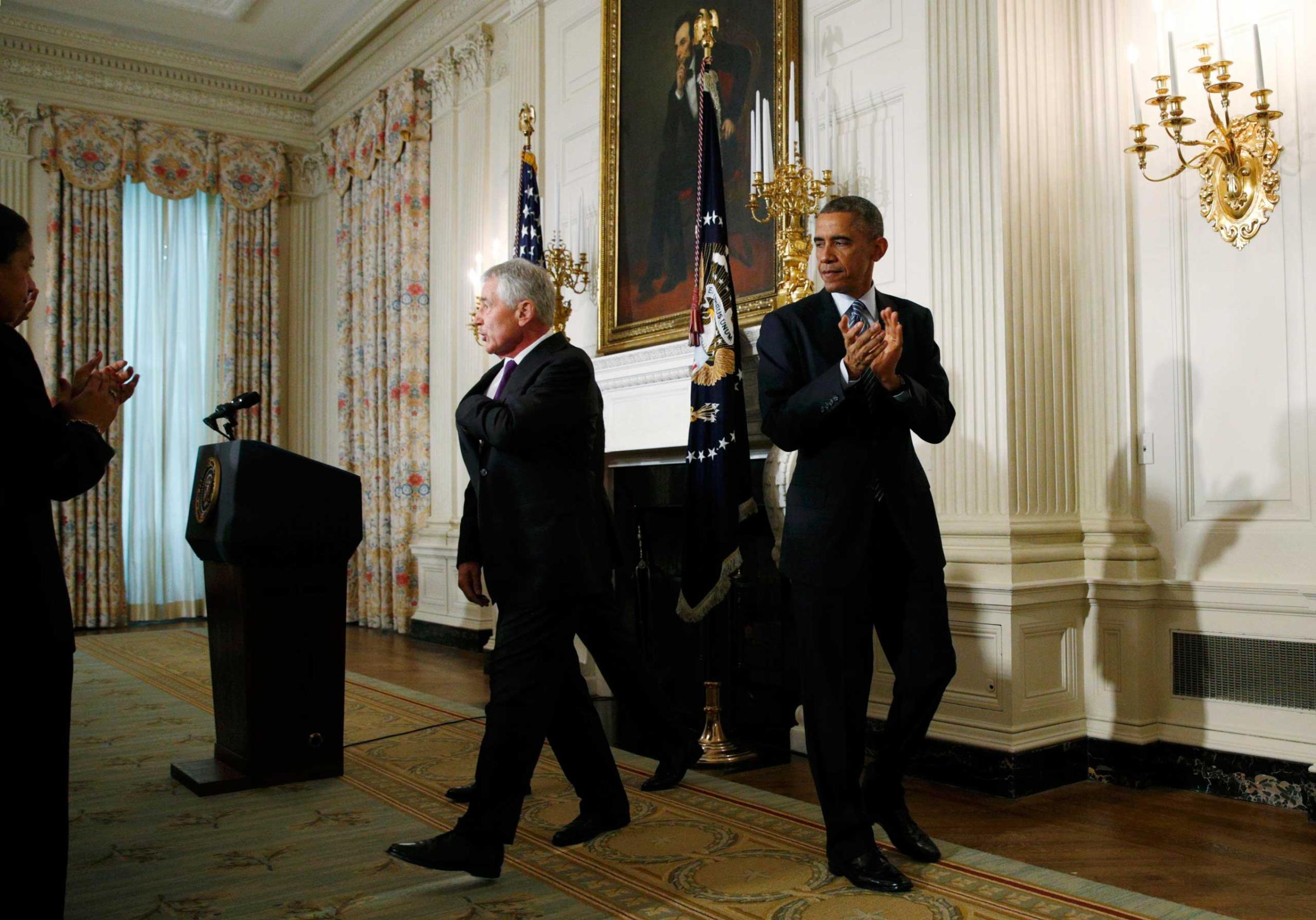 U.S. President Obama escorts Secretary of Defense Hagel out of the State Dining Room after they announced Hagel's resignation at the White House in Washington