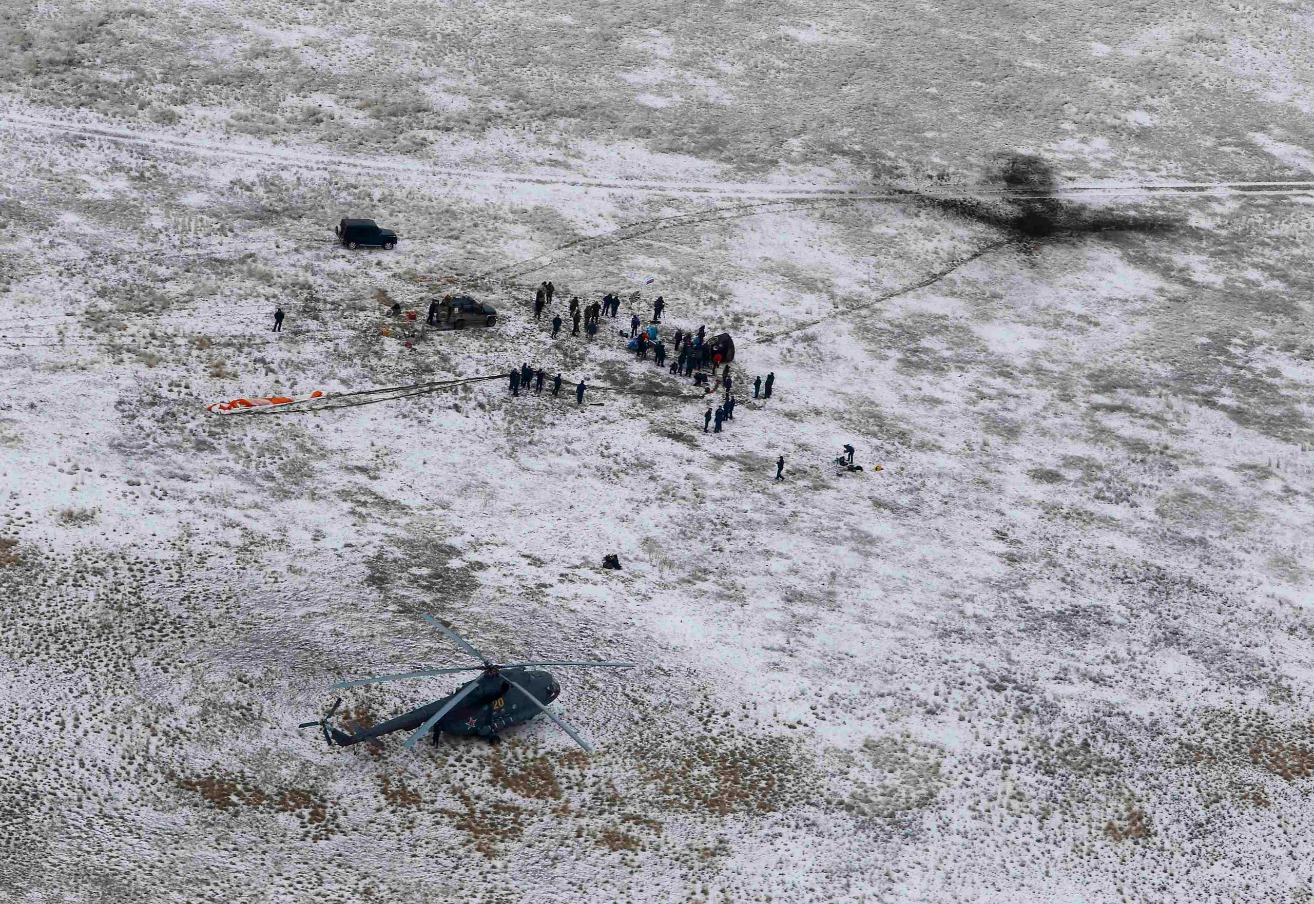 Nov. 10, 2014. Search and rescue team approaches the Soyuz TMA-13M capsule with the International Space Station (ISS) crew, Alexander Gerst of Germany, Maxim Surayev of Russia and Reid Wiseman of the U.S. after its landing near the town of Arkalyk, in northern Kazakhstan.