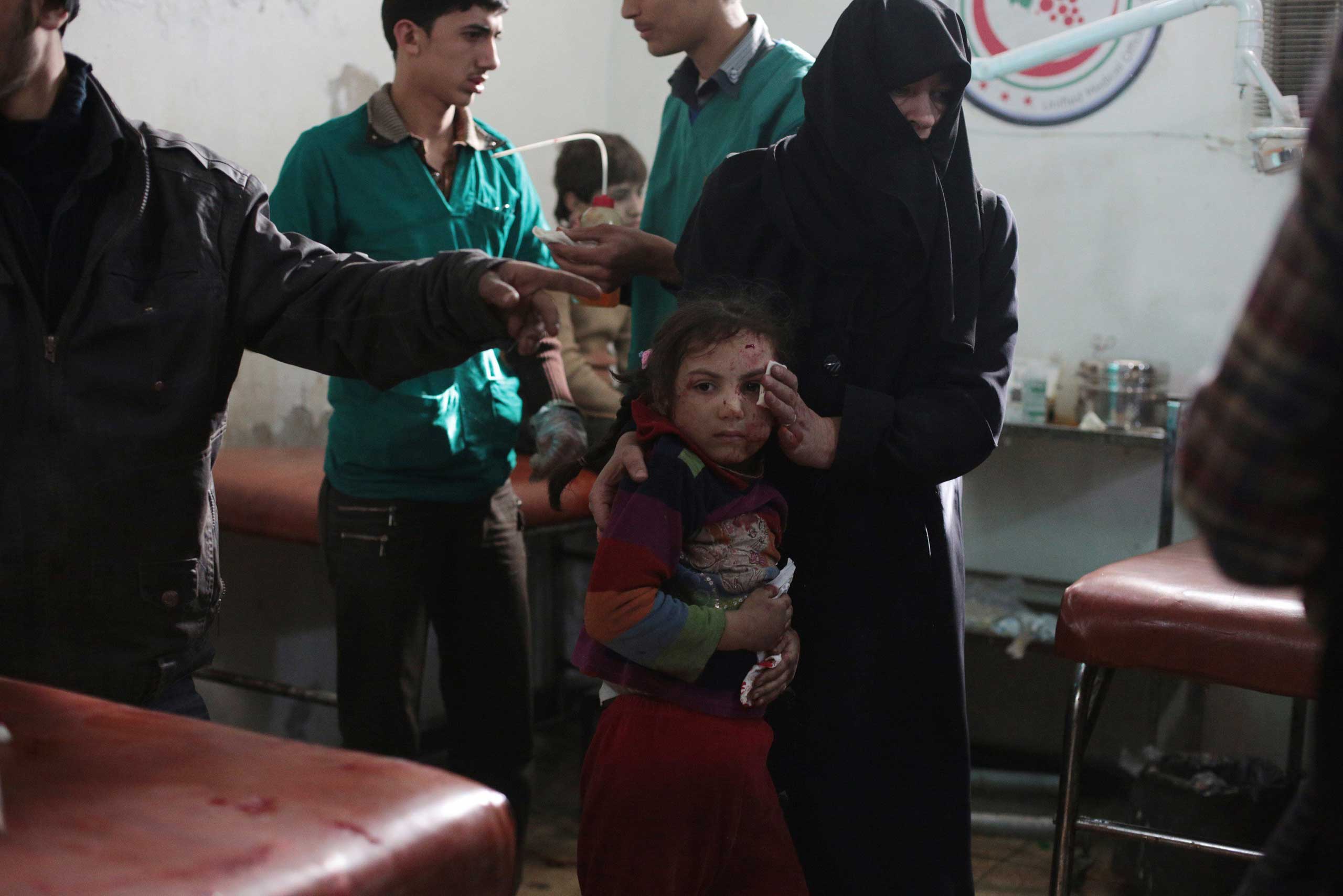 Nov. 11, 2014. A Syrian woman brings a wounded girl for treatment at a makeshift hospital in the rebel-held Damascus suburb of Douma, following a reported air strike by government forces on the town, 8 miles northeast of the Syrian capital.