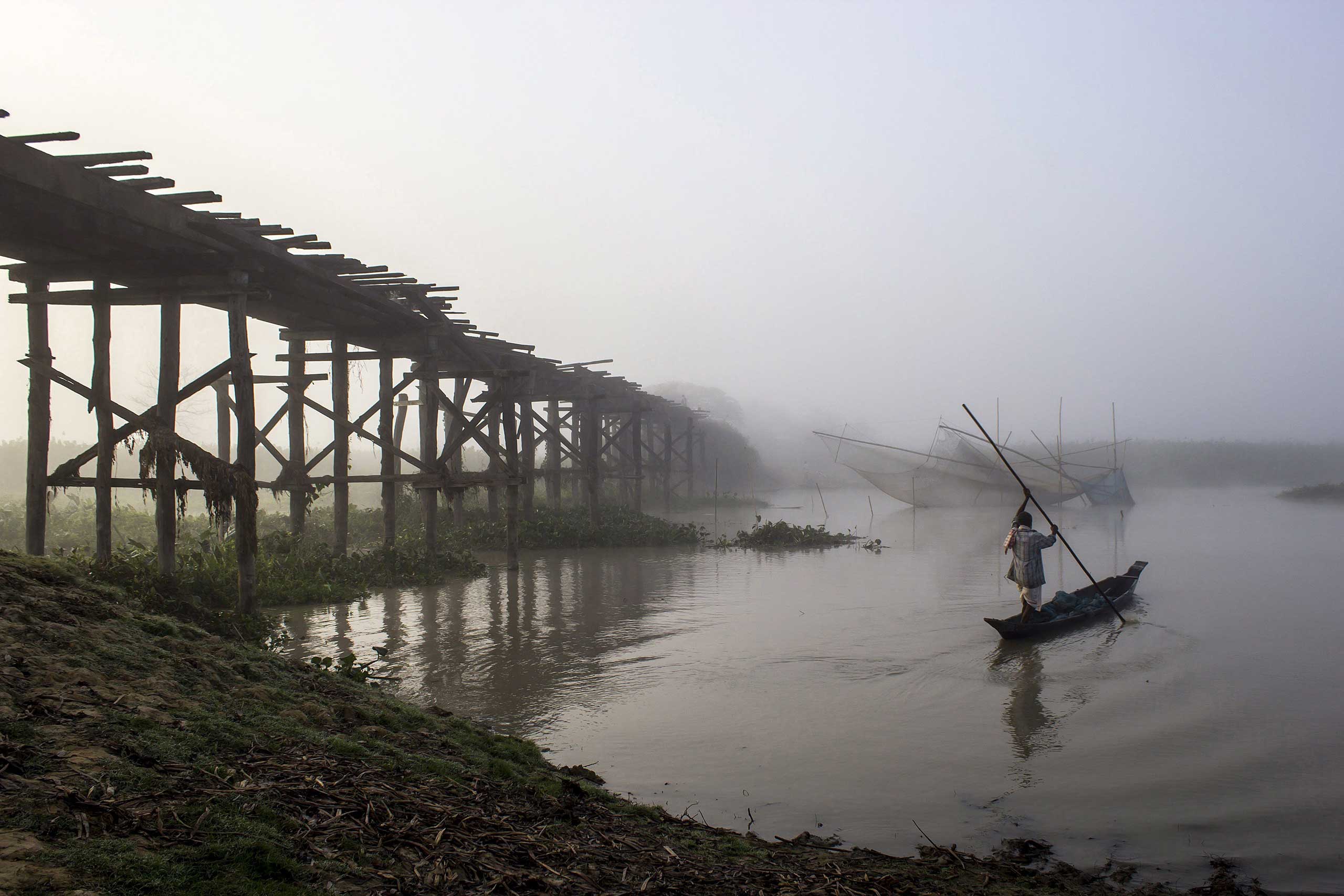Nov. 12, 2014. An Indian fisherman rows his boat towards his fishing nets on a misty morning on the outskirts of Sivasagar district, in eastern Assam state. Temperatures country-wide are slowly dropping as winter is setting in.