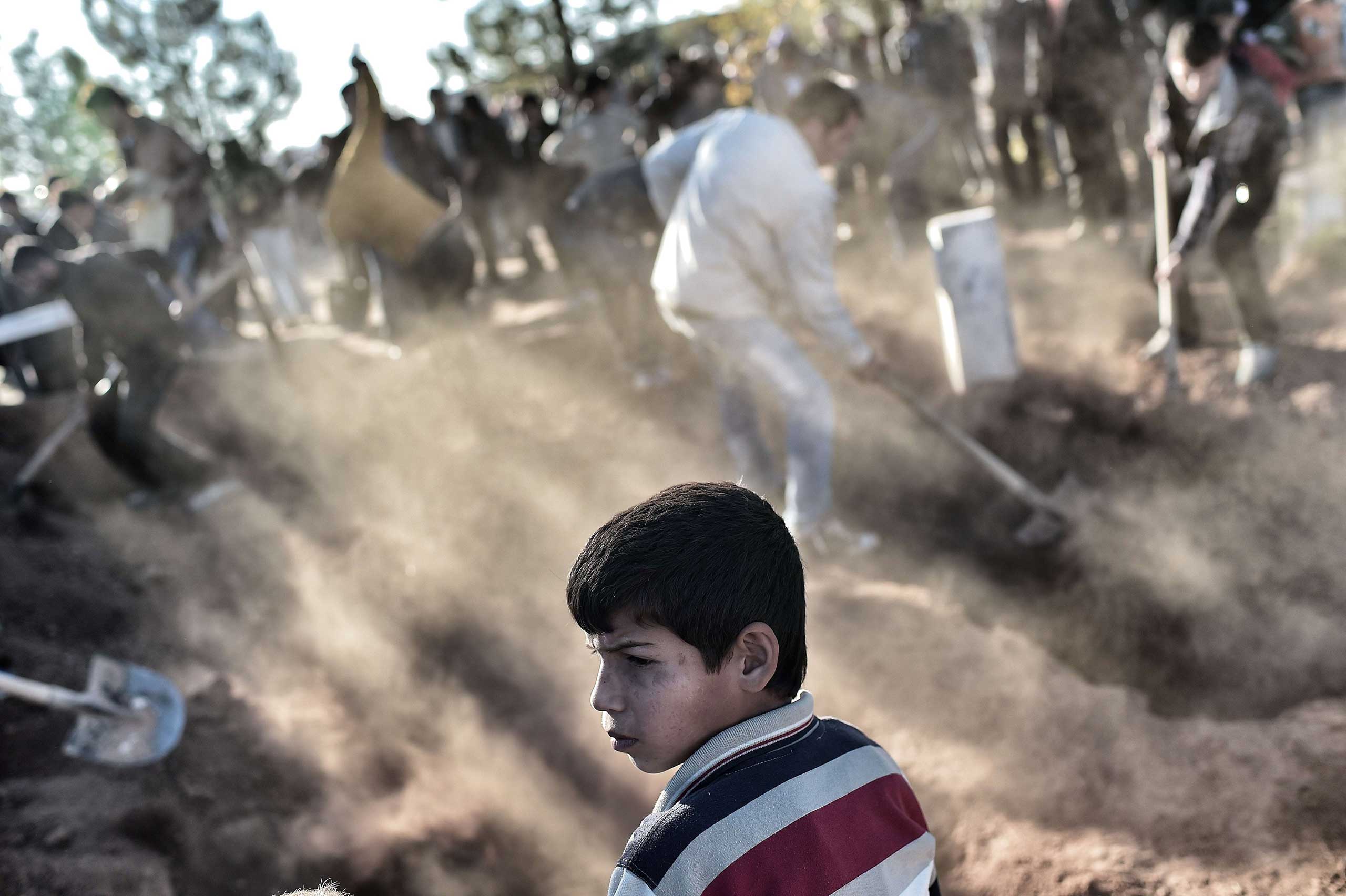 Nov. 7, 2014. A young boy looks on as he attends the funeral of a Kurdish Women's Protection Unit (YPJ) fighter who died during fighting in the besieged Syrian border town of Kobane, in the town of Suruc, Sanliurfa province in Turkey.