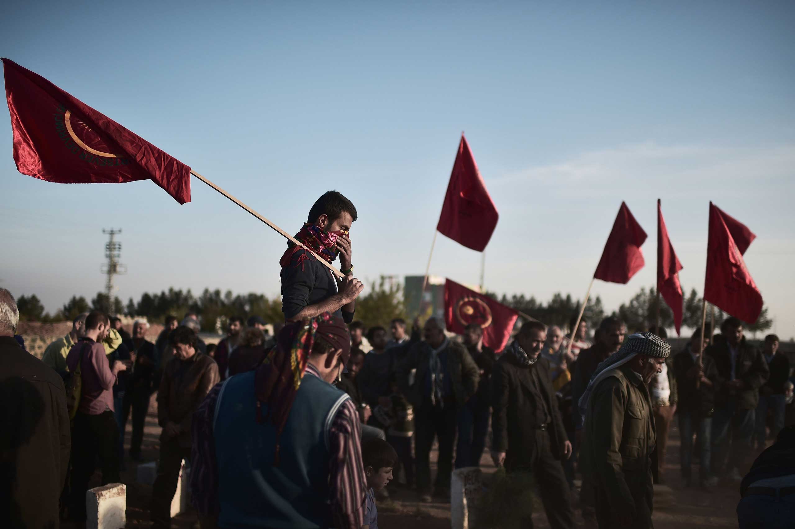 Nov. 12, 2014. Kurdish people gather in the Turkish town of Suruc in the Sanliurfa province to attend the funeral of a People's Protection Units (YPG) fighter who died while fighting in the Syrian Kurdish flashpoint town of Kobane, also known as Ayn al-Arab.