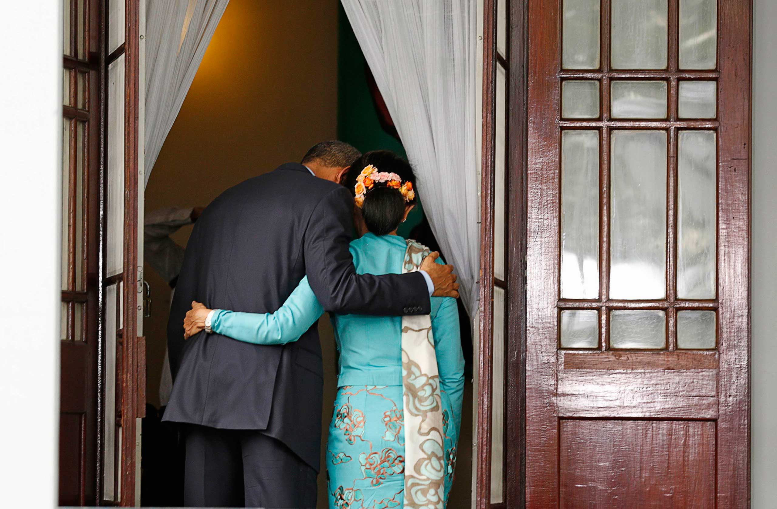 Nov. 14, 2014. U.S. President Barack Obama puts his arm around opposition politician Aung San Suu Kyi after a joint press conference following their meeting at her residence in Yangon. Obama said a provision in the Southeast Asian nation's constitution that prevents candidates from running for president because of their children's nationality made no sense.