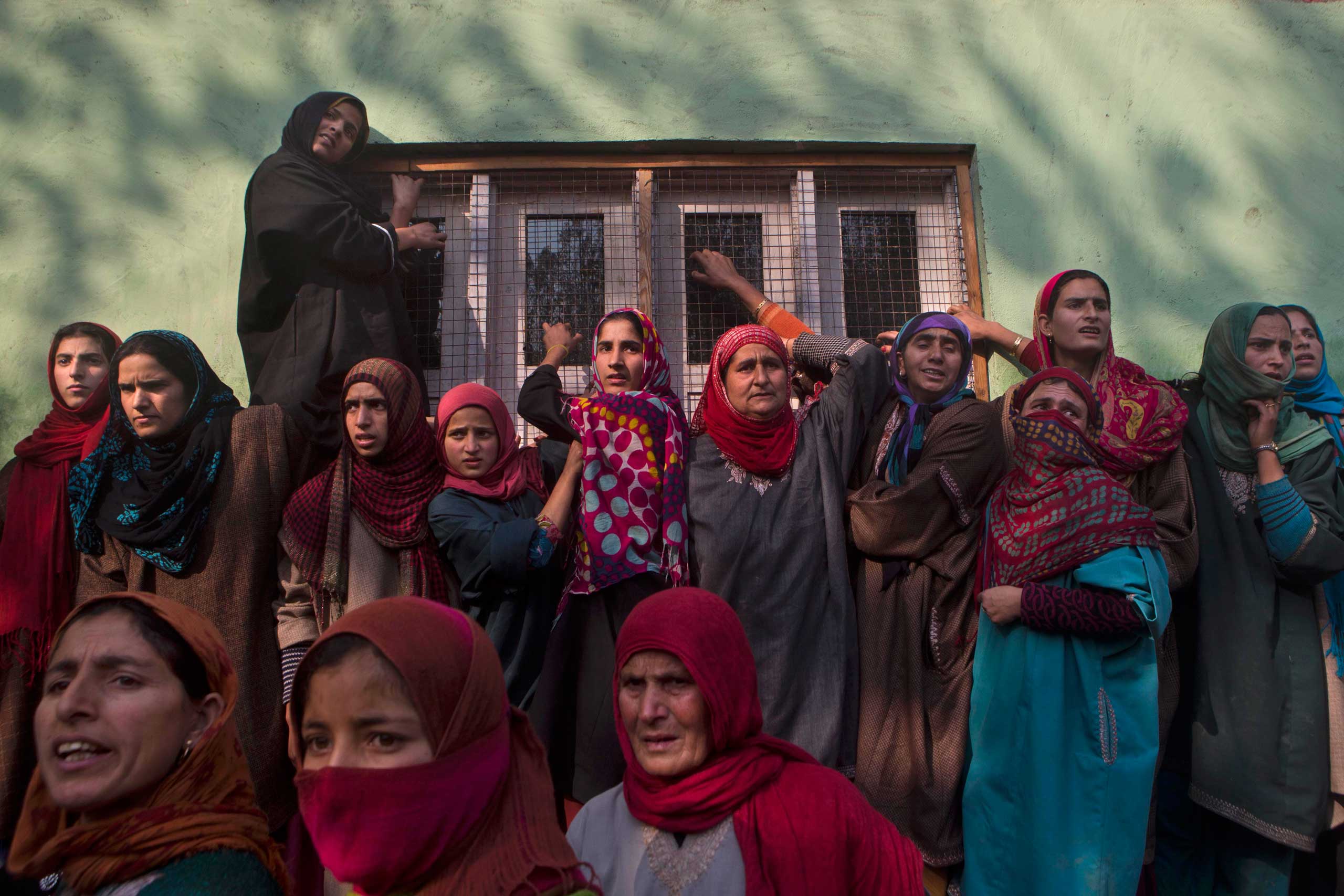 Nov. 14, 2014. Kashmiri villagers watch the funeral procession of Mohammad Abas Malla, a suspected rebel, at Nowpora village, south of Srinagar, India. Two suspected rebels and a civilian were killed in a fierce gunbattle in the Indian-controlled portion of Kashmir, an Indian security official said Friday.