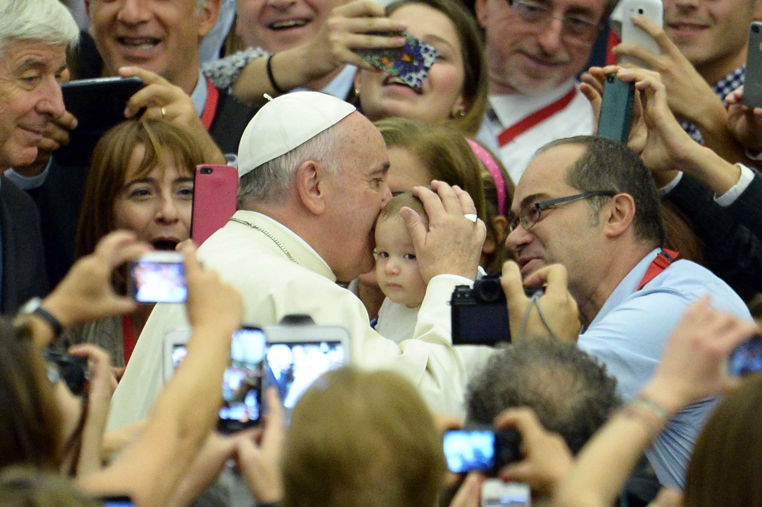 Pope Francis kisses a baby during an audience with members of the Association of Italian Catholic Doctors at Paul VI audience hall at the Vatican on Nov. 15, 2014. (Filippo Monteforte—AFP/Getty Images)