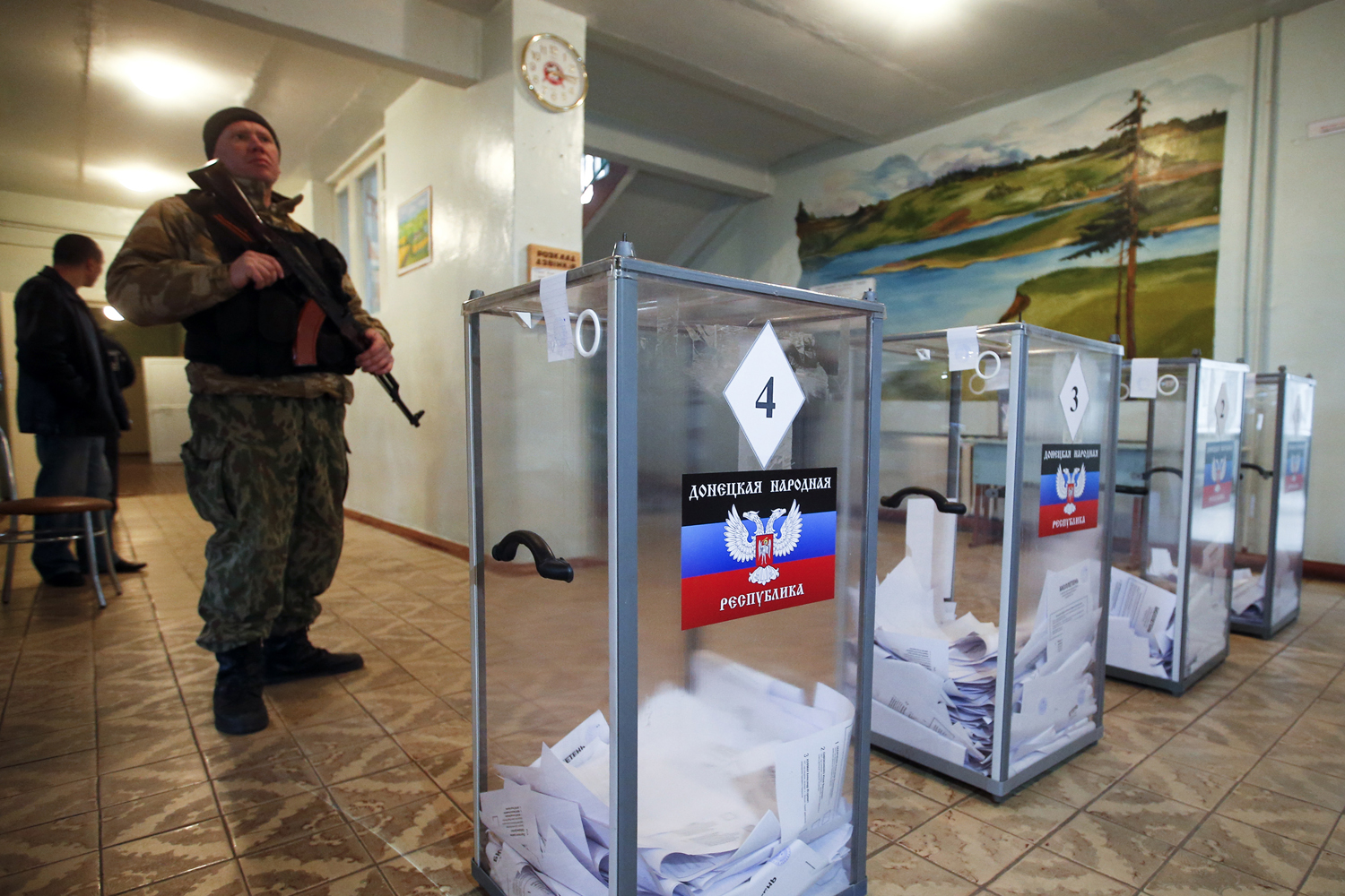 A pro-Russian separatist stands guard during the self-proclaimed Donetsk People's Republic leadership and local parliamentary elections at a polling station near Donetsk on Nov. 2, 2014 (Maxim Zmeyev—Reuters)