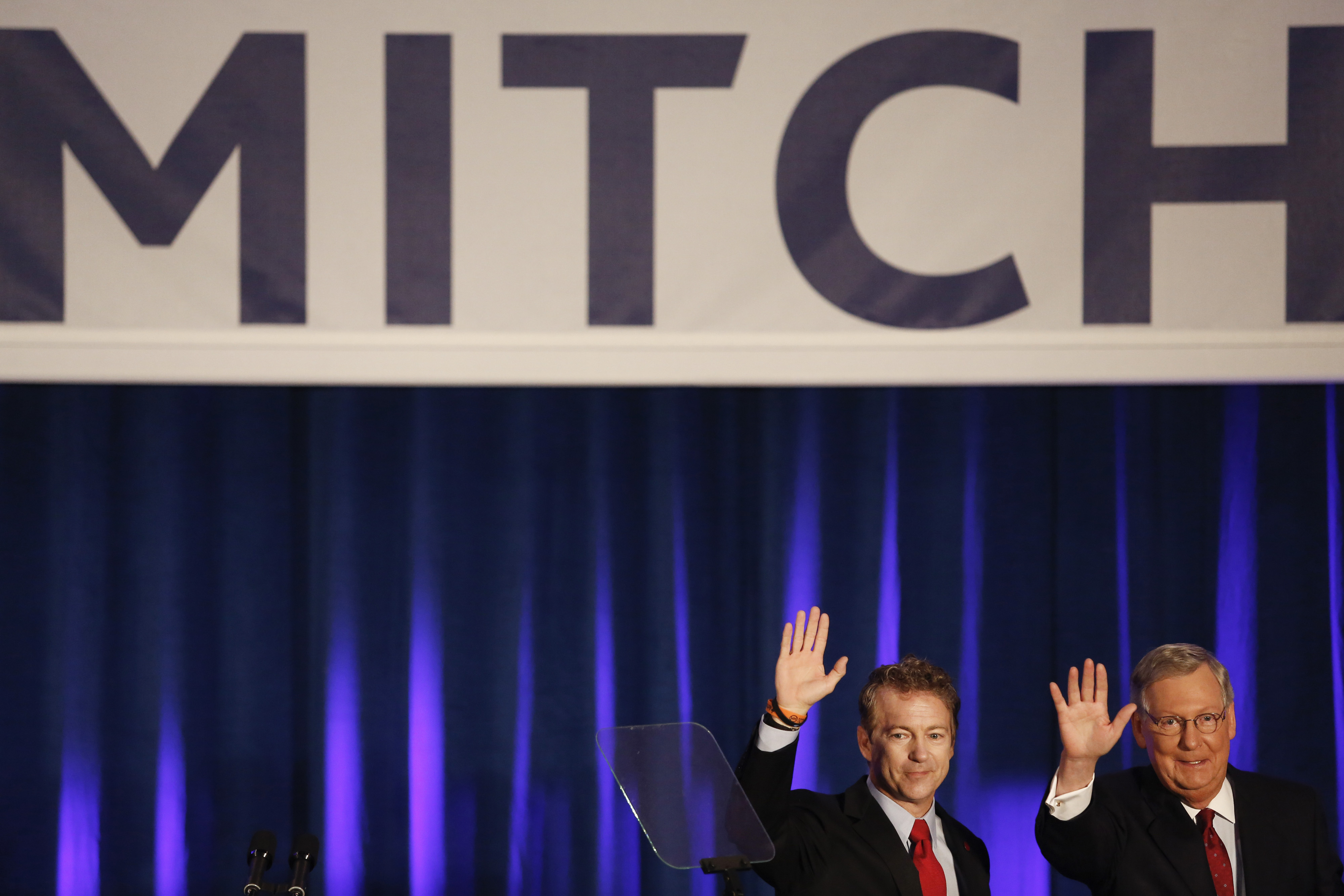 Senate Minority Leader Mitch McConnell and Senator Rand Paul wave to supporters at a Republican Party of Kentucky election night party in Louisville on  Nov. 4, 2014. (Luke Sharrett—Bloomberg/Getty Images)