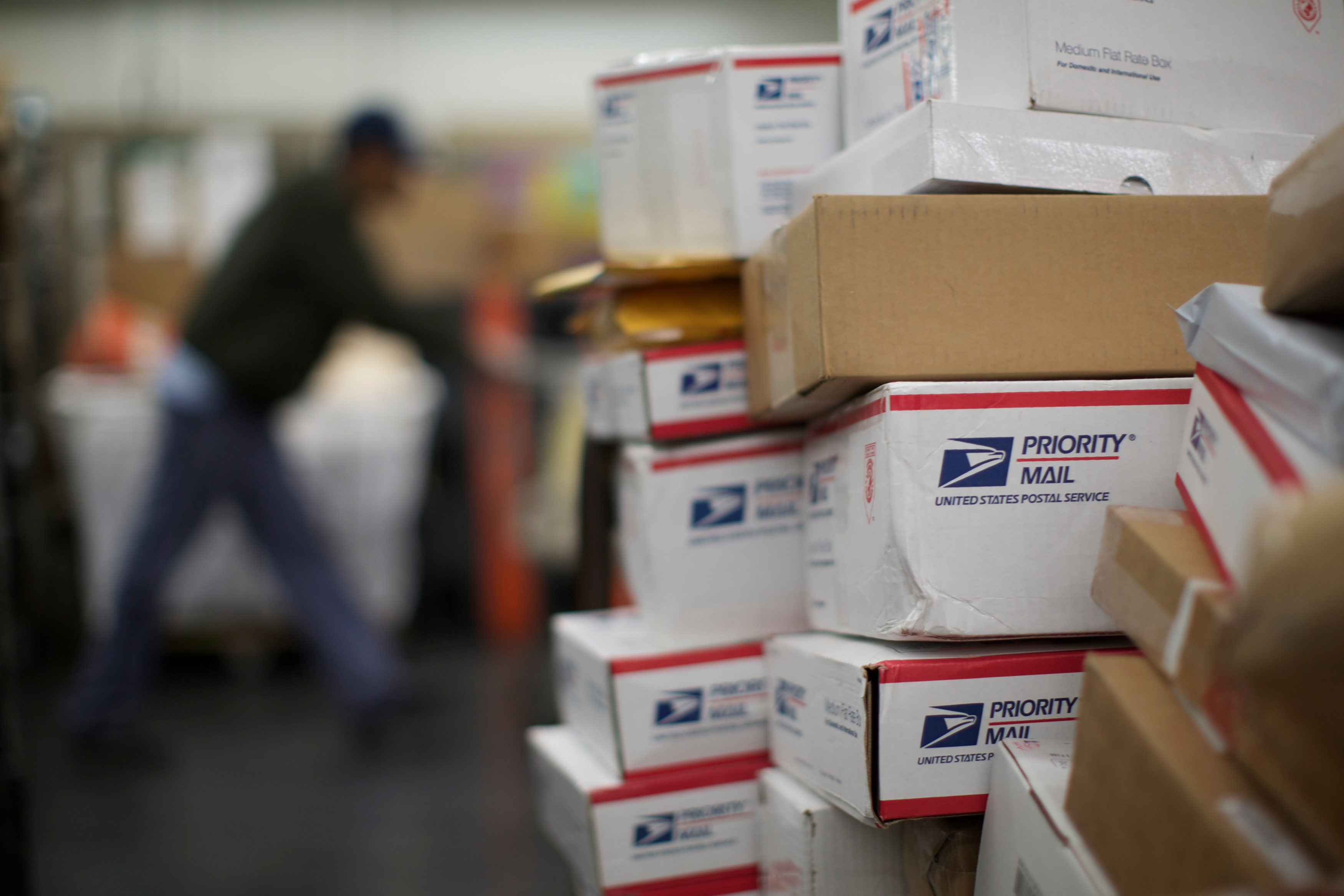 USPS mail clerks sort packages in Chicago, November 29, 2012. A new Gallup poll shows that most Americans think the post office is doing a good or excellent job despite its financial difficulties. (John Gress—Reuters)