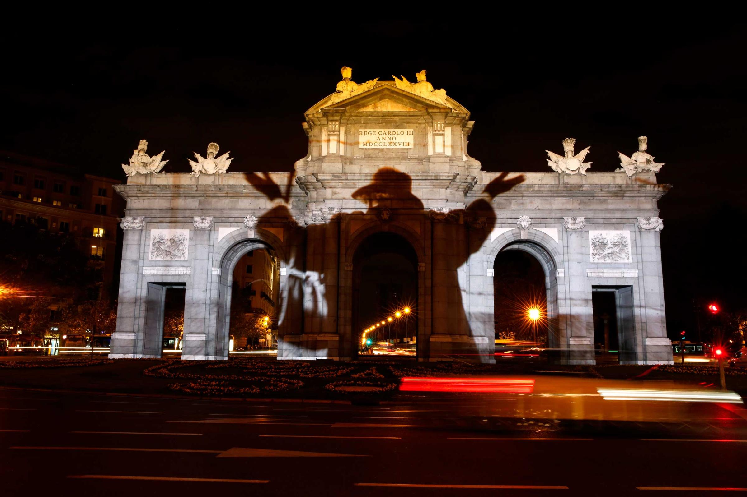 Historic image commemorating the former Berlin Wall is projected on Alcala Gate in Madrid