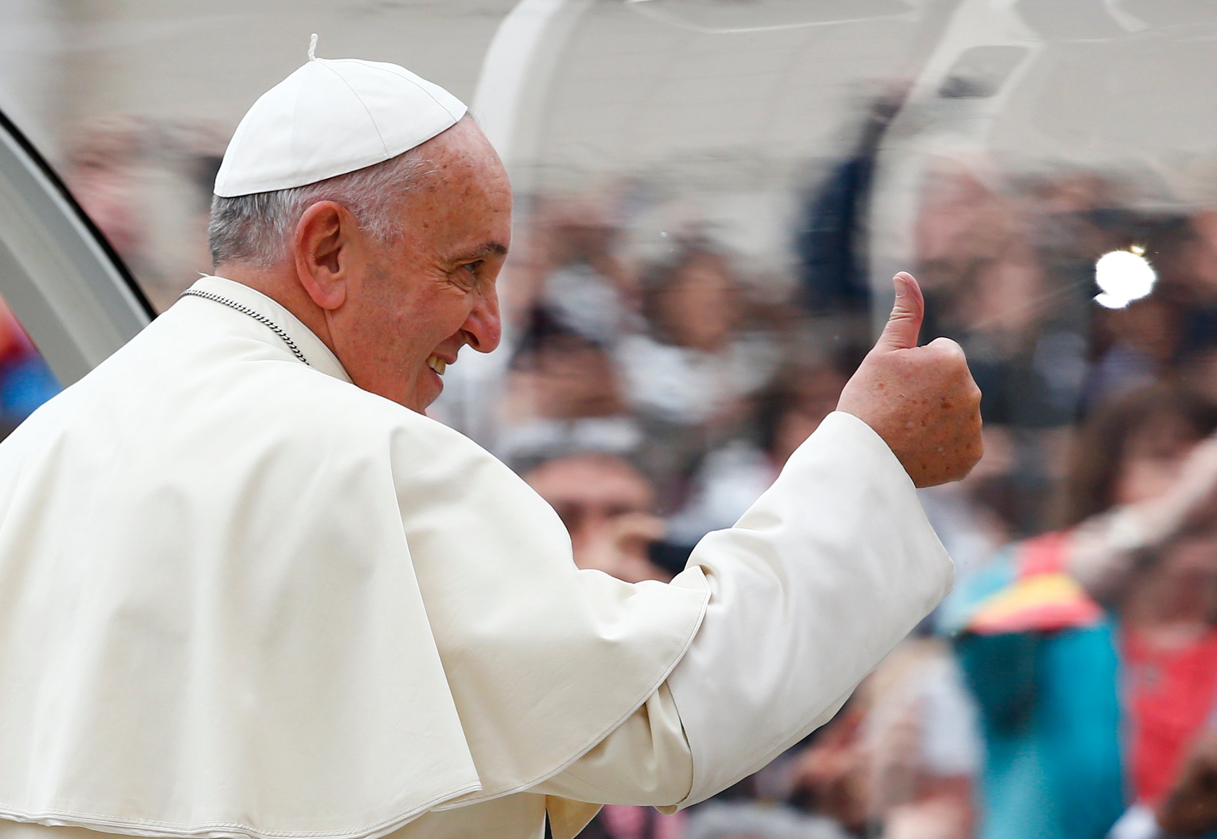 Pope Francis gestures as he arrives to lead his weekly general audience in Saint Peter's Square at the Vatican