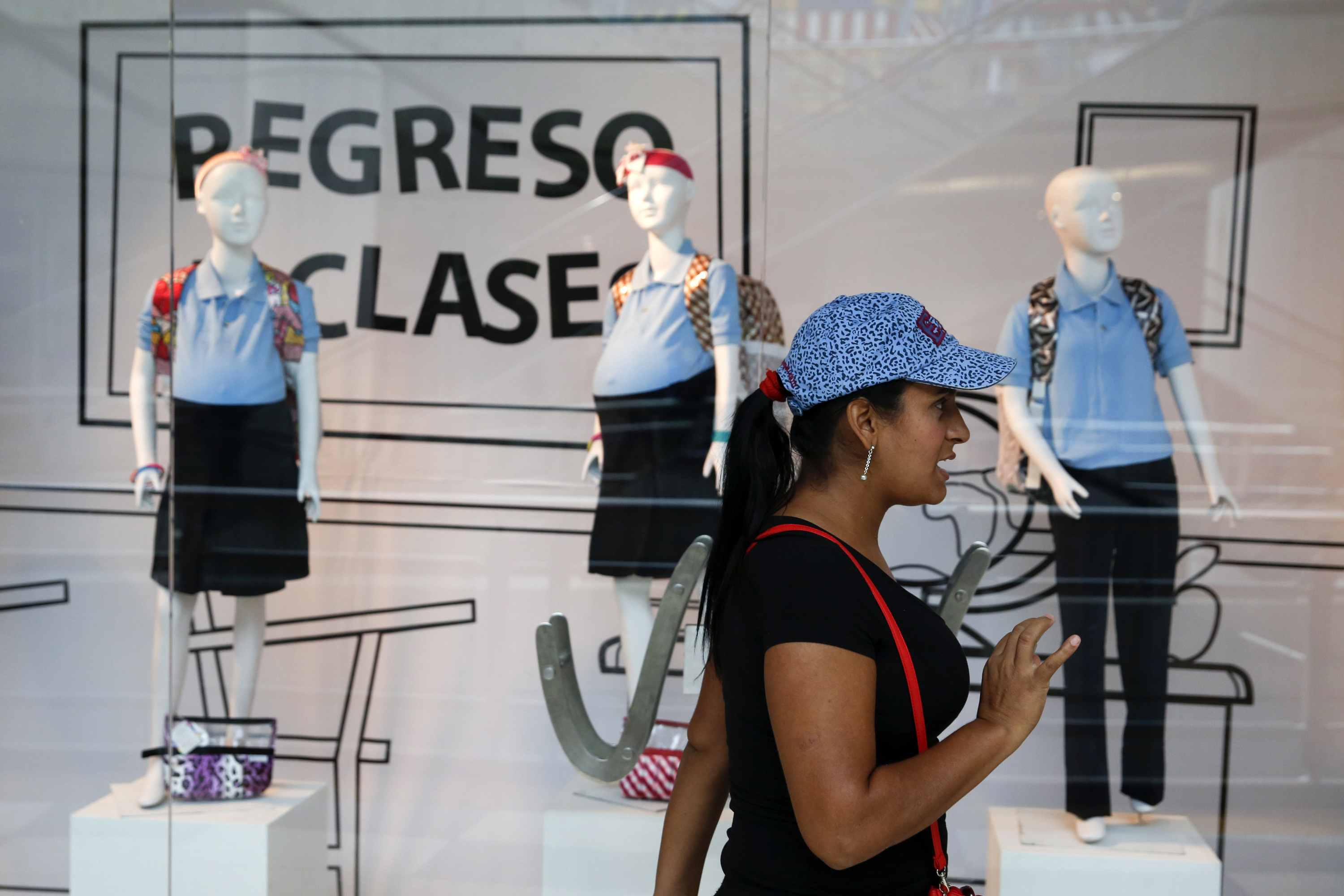 A woman reacts in front of a display showing mannequins of pregnant schoolgirls at a shopping mall in Caracas November 12, 2014. (Carlos Garcia Rawlins&mdash;Reuters)