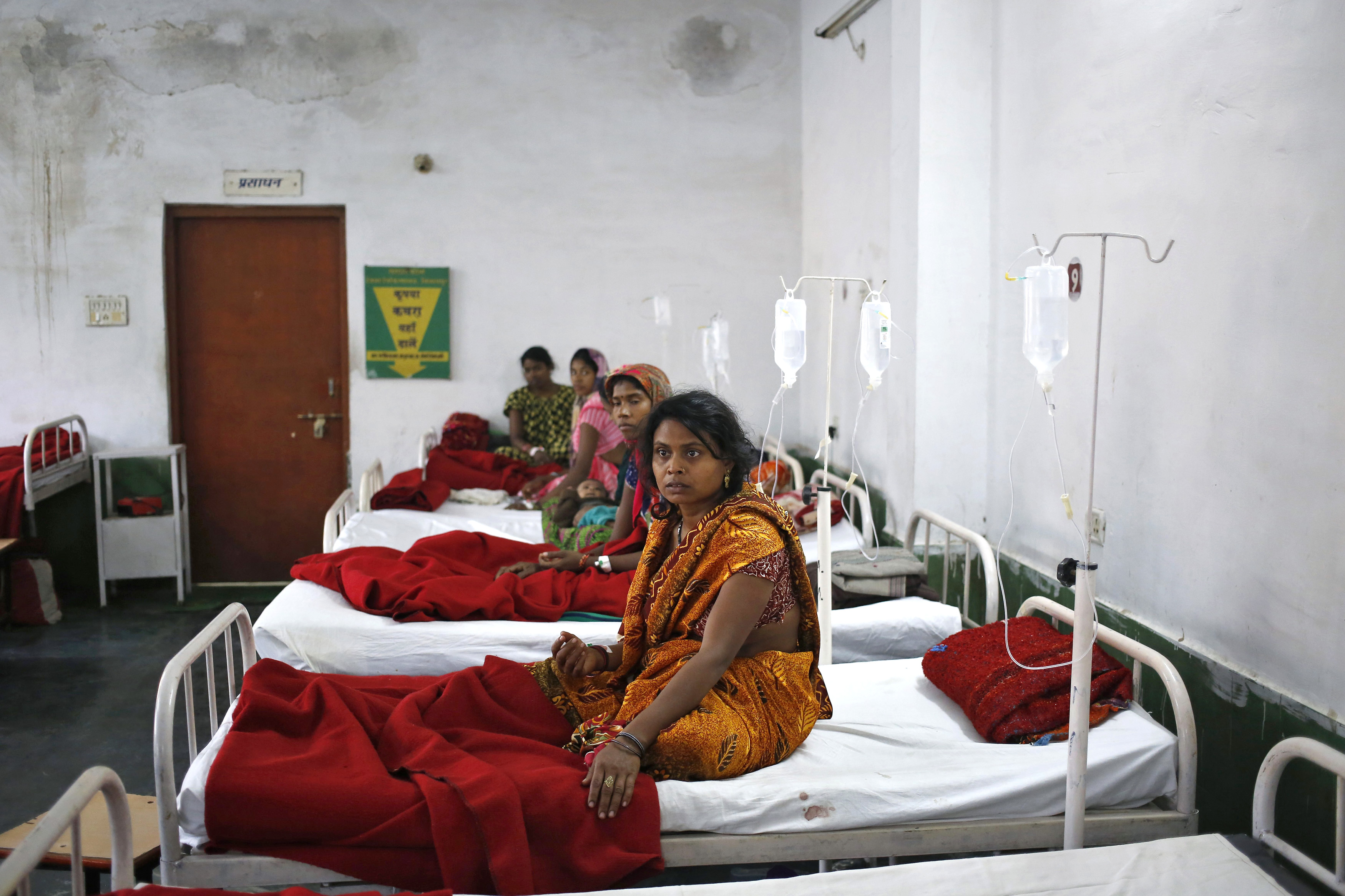 Women, who underwent a sterilization surgery at a government mass-sterilization "camp," lie in hospital beds for treatment at the Chhattisgarh Institute of Medical Sciences hospital in Bilaspur, in the eastern Indian state of Chhattisgarh, on Nov. 13, 2014 (Anindito Mukherjee—Reuters)