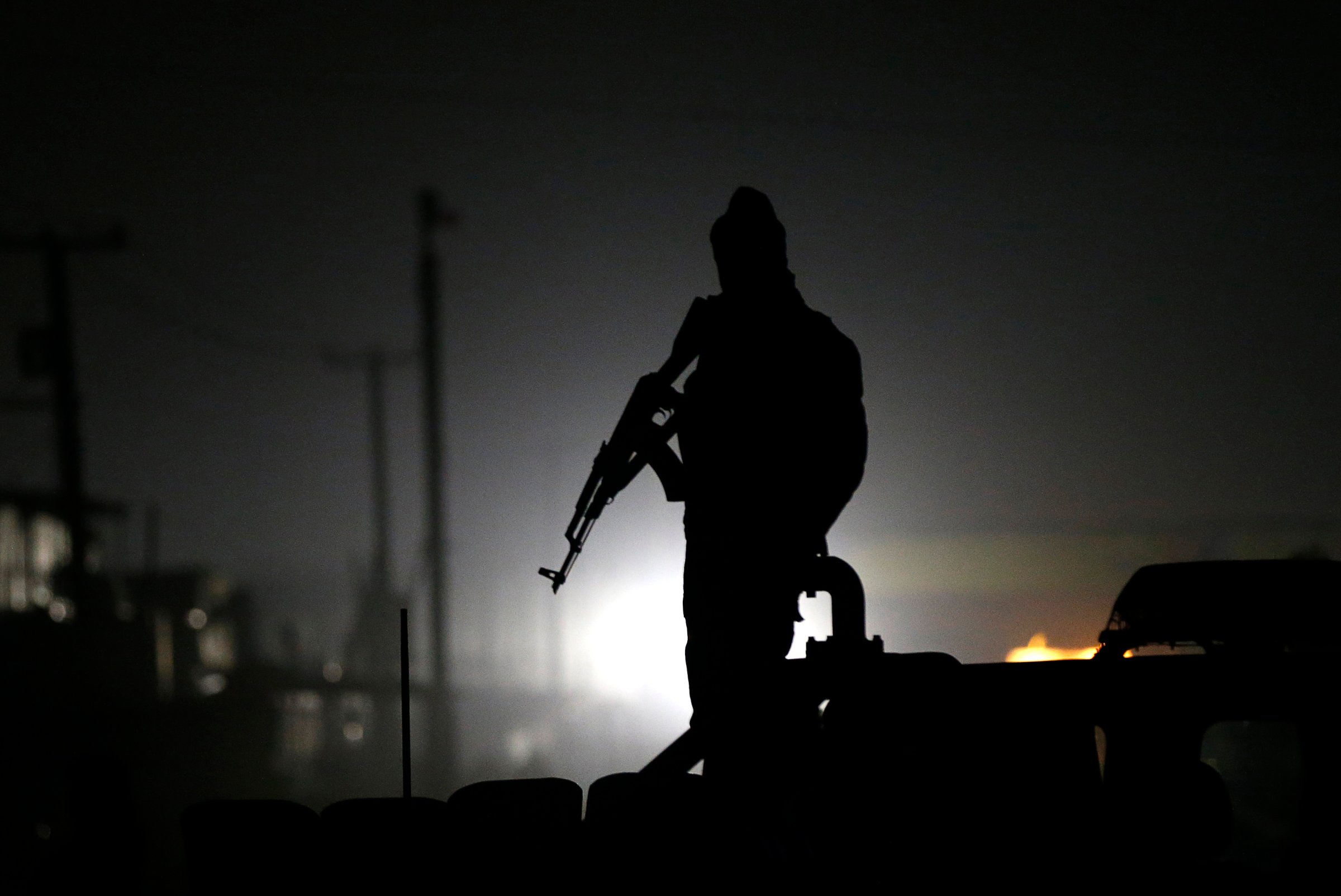 Afghan policeman keeps watch at the site of a Taliban attack in Kabul