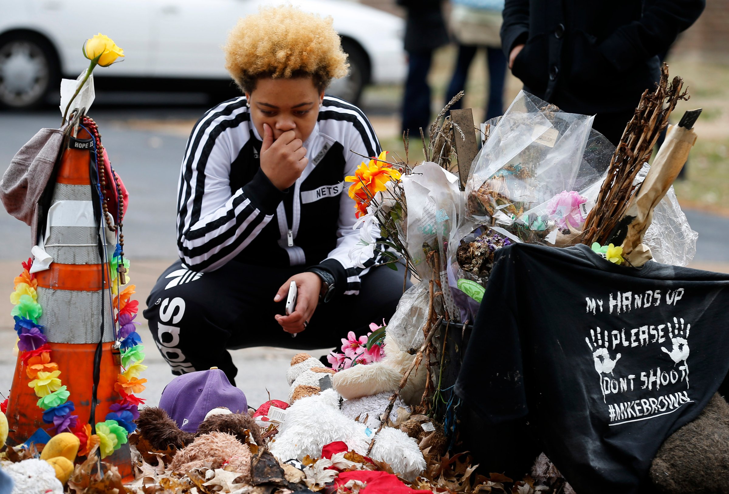 Woman stops to visit the memorial set up where Michael Brown was shot and killed in Ferguson