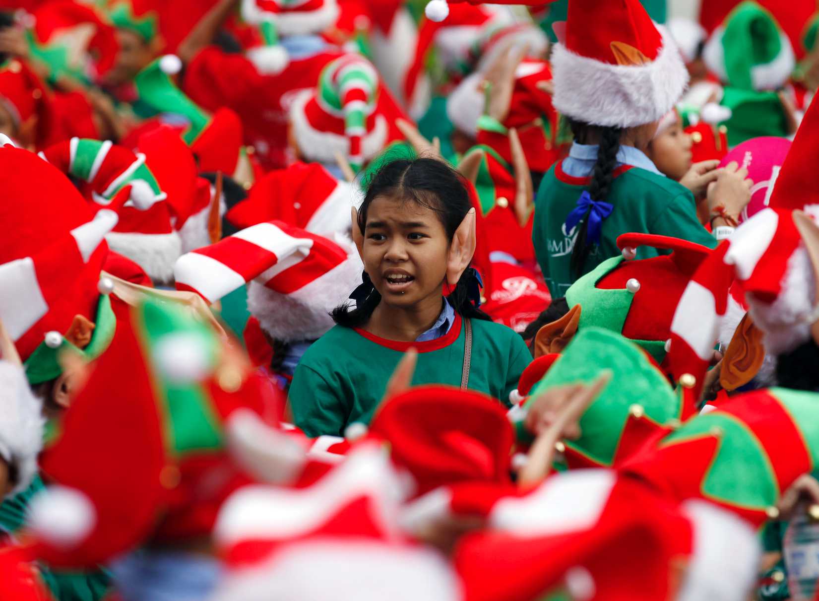 Students gather to break the Guinness World Record for the largest gathering of Christmas elves outside a shopping mall in Bangkok on Nov. 25, 2014 (Chaiwat Subprasom—Reuters)