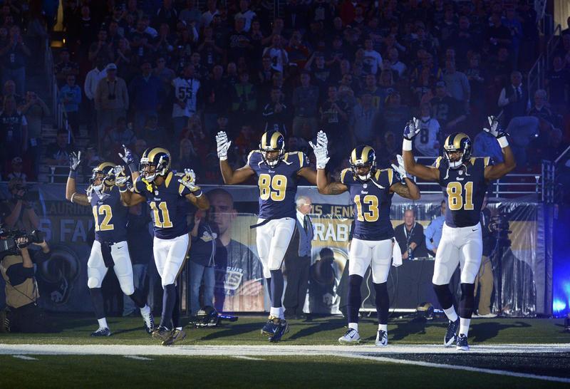 St. Louis Rams players put their hands up to show support for Michael Brown before a game against the Oakland Raiders at the Edward Jones Dome, St. Louis, on Nov. 30, 2014 (USA Today Sports—Reuters)
