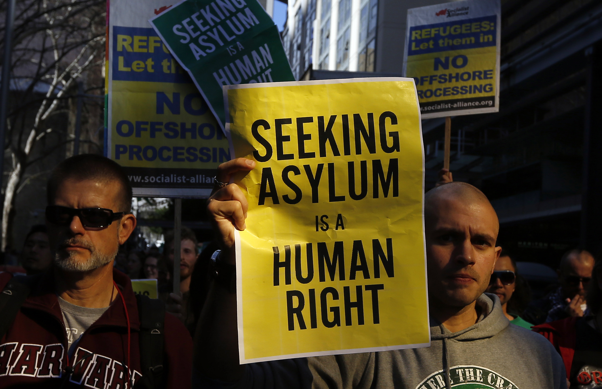 A man holds a poster during a rally in support of asylum seekers in central Sydney July 20, 2013 (Daniel Munoz—Reuters)