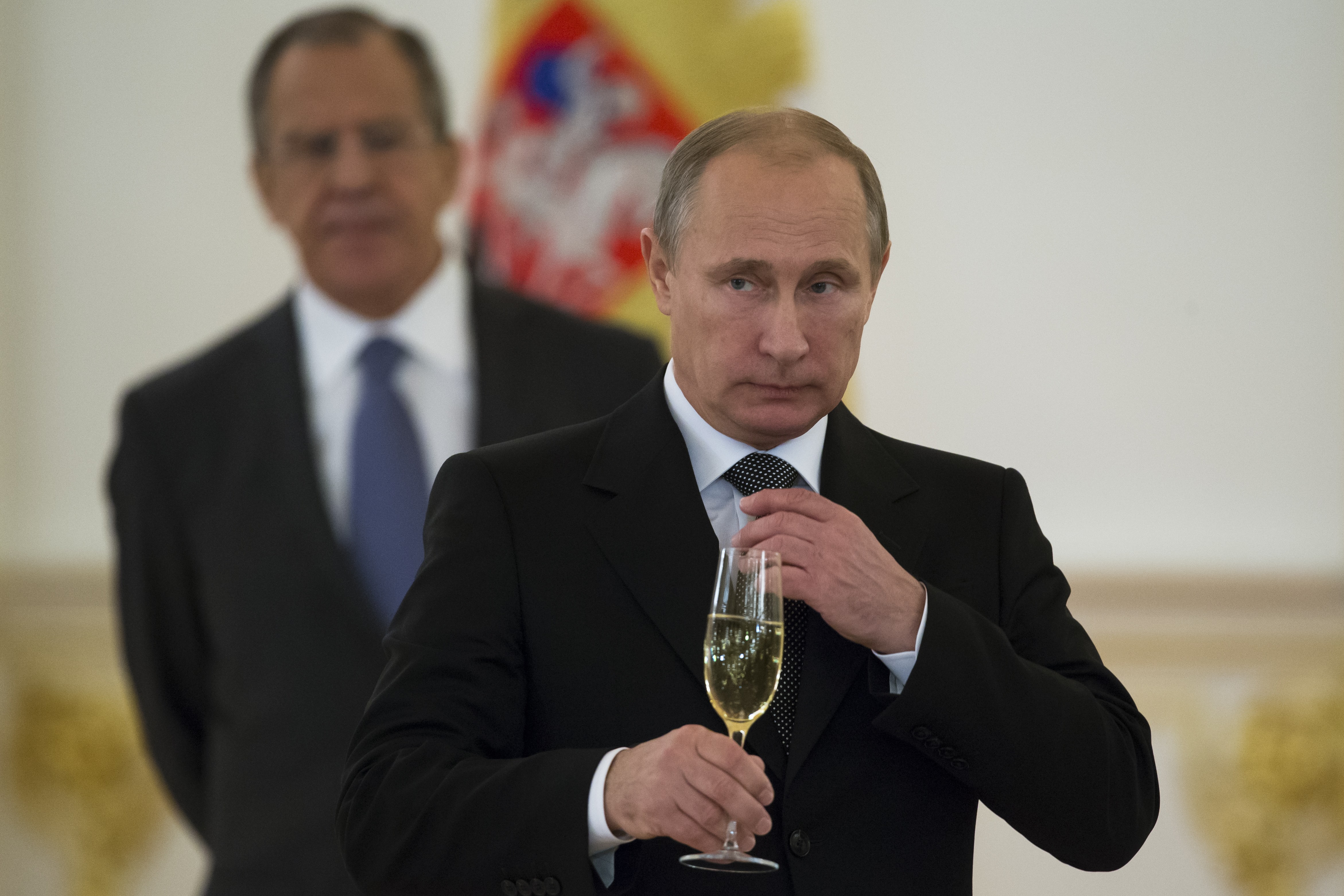 Russian President Vladimir Putin prepares to toast with ambassadors in the Alexander Hall after a ceremony of presentation of credentials by foreign ambassadors in the Grand Kremlin Palace in Moscow, Russia, Wednesday, Nov. 19, 2014. (Alexander Zemlianichenko—AP)
