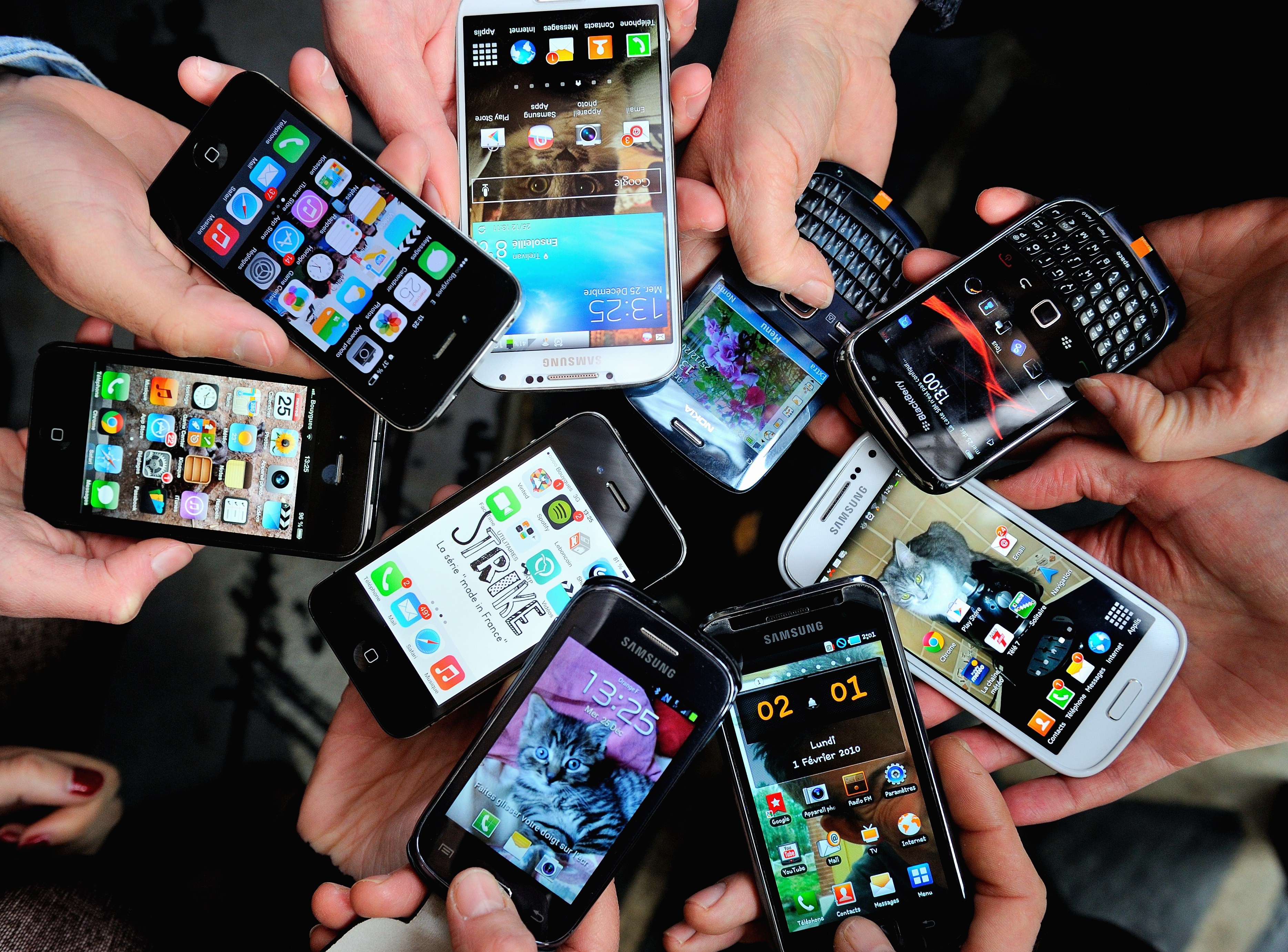 People show their smartphones on December 25, 2013 in Dinan, northwestern France. (Philippe Huguen&mdash;AFP/Getty Images)