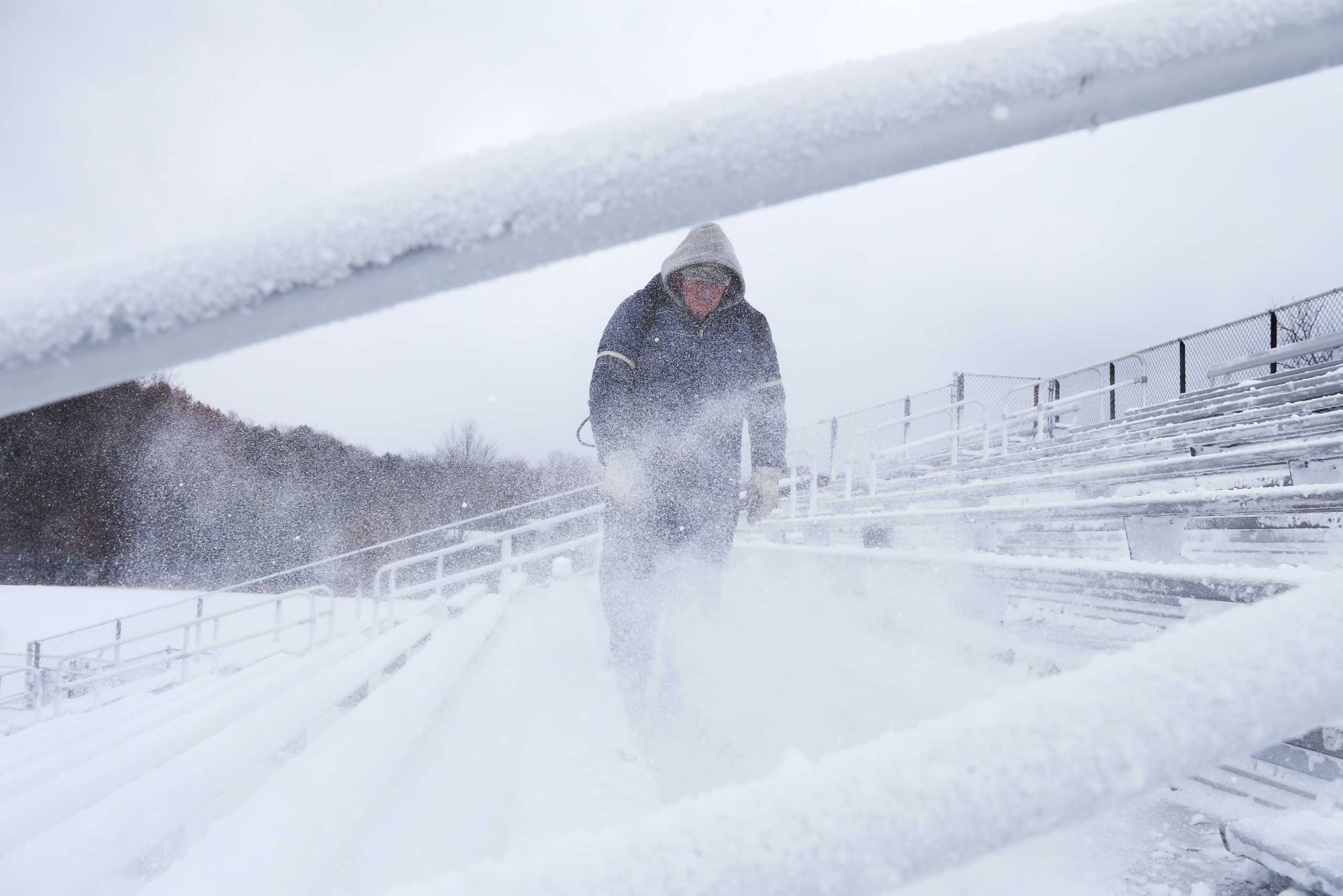 Jack Timmer uses a snow blower to remove snow from the Sailors Stadium before the Mona Shores High School football game in Norton Shores, Mich. on Nov. 14, 2014. (Andraya Croft—The Muskegon Chronicle/AP)