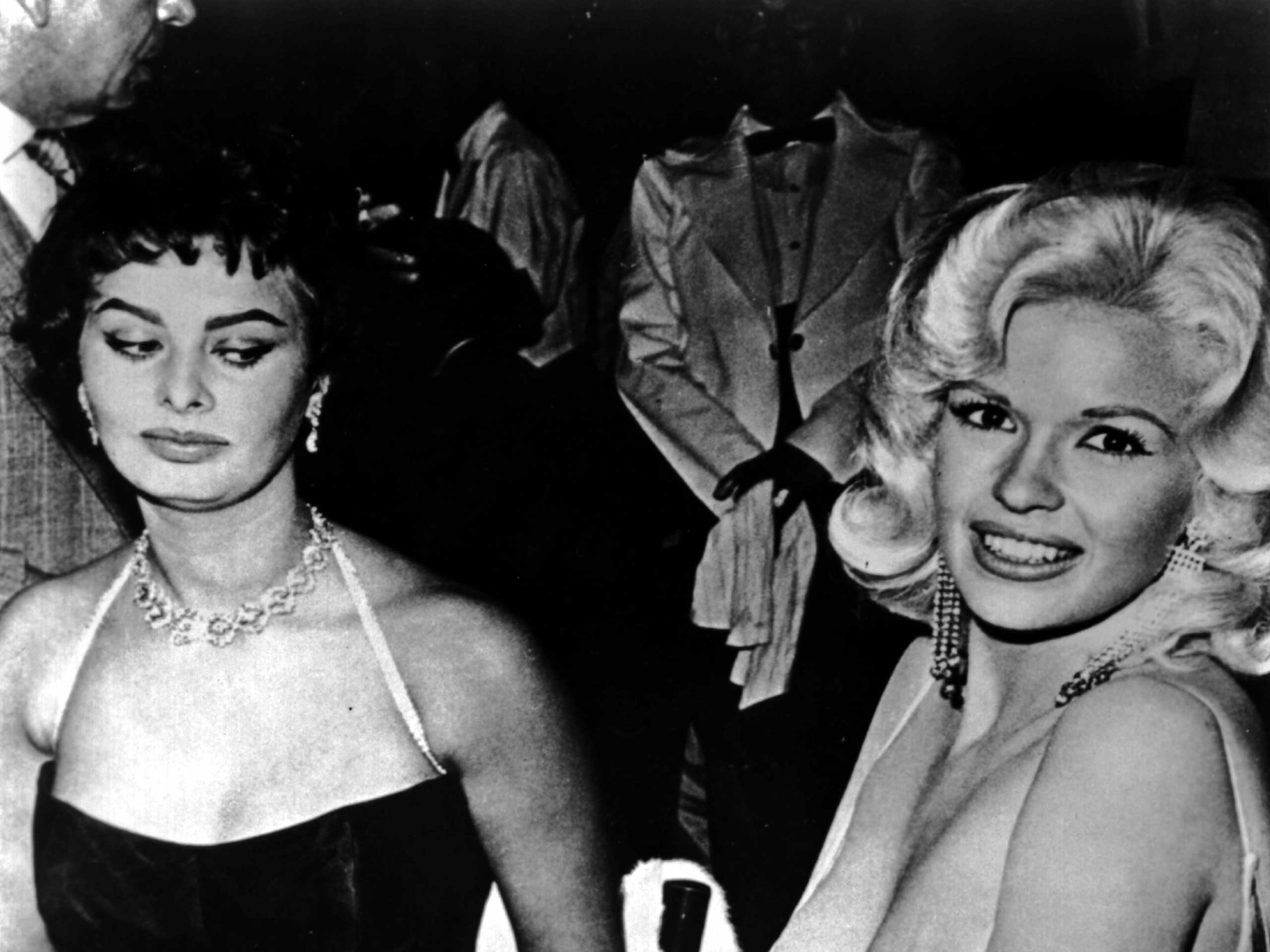 Jayne Mansfield tries to steal the show in a very low cut dress at a party thrown by 20th Century-Fox for Sophia Loren on April 12, 1957 in Los Angeles. (Moviestore Collection/Re/REX USA)