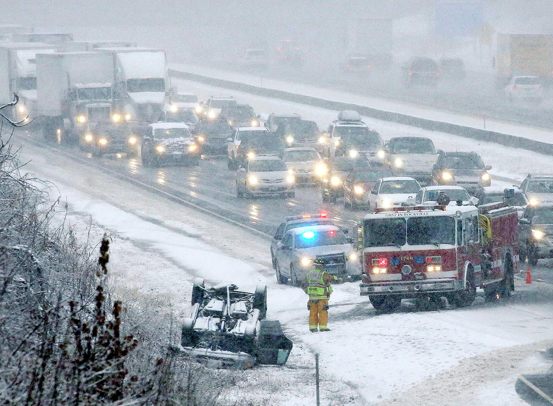 An over-turned automobile on Interstate 84 snarls traffic, Wednesday, Nov. 26, 2014 in Vernon, Conn. (Jared Ramsdell—AP)