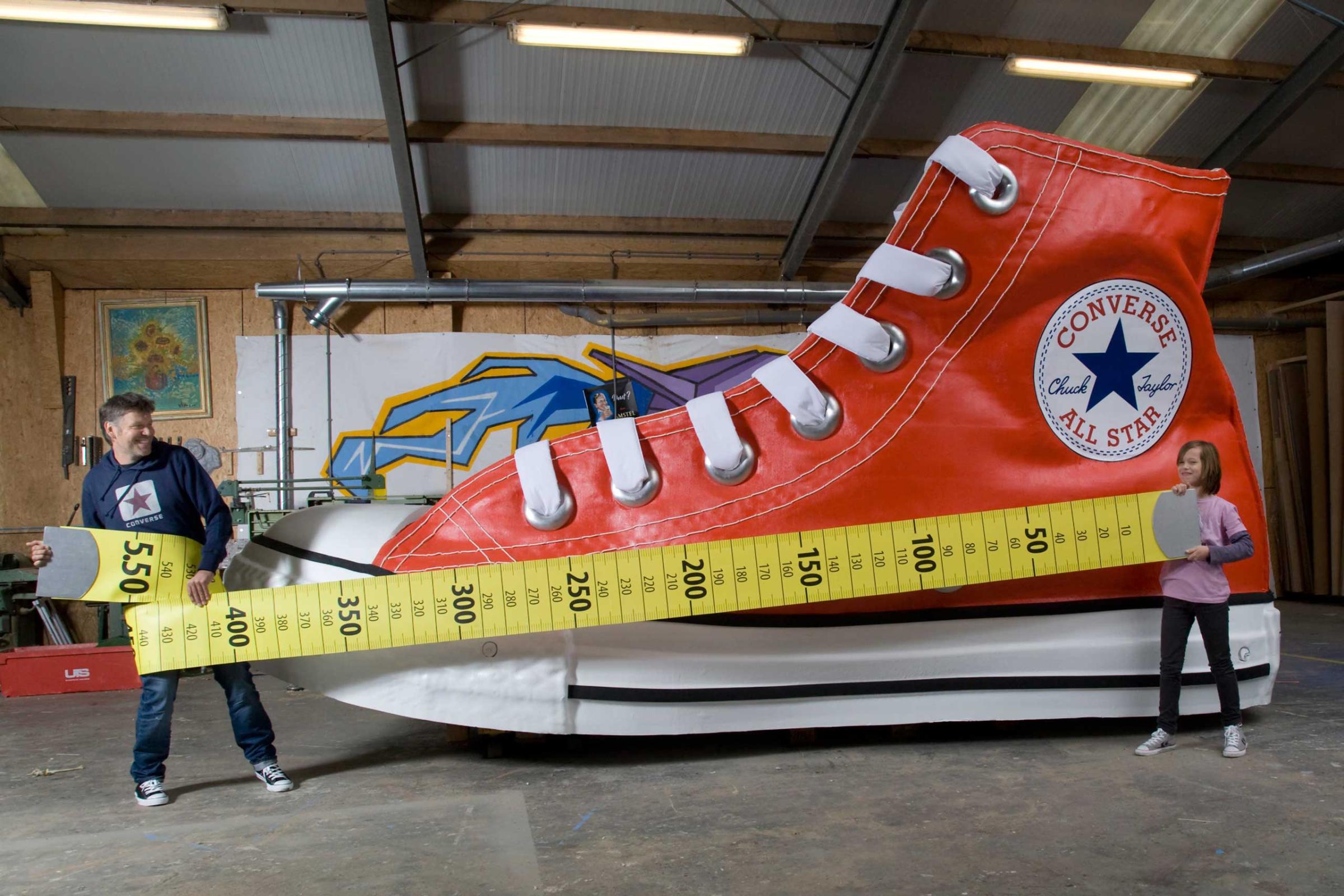 Largest ShoeAttempt Text The largest shoe measures 5.50 m (18 ft 0.53 in) x 2.11 m (6 ft 11.07 in) and is 2.90 m (9 ft 6.17 in) high and was unveiled by the Nationaal Fonds Kinderhulp (Netherlands) in Amsterdam, the Netherlands, on 17 November 2010, in celebration of Guinness World Records Day 2010. Further Info The largest shoe is an exact replica of a Converse Chuck Taylor All Star equivalent of a UK size 845. A Converse Chuck Taylor All Star European size 39 was used as a model for the largest shoe.