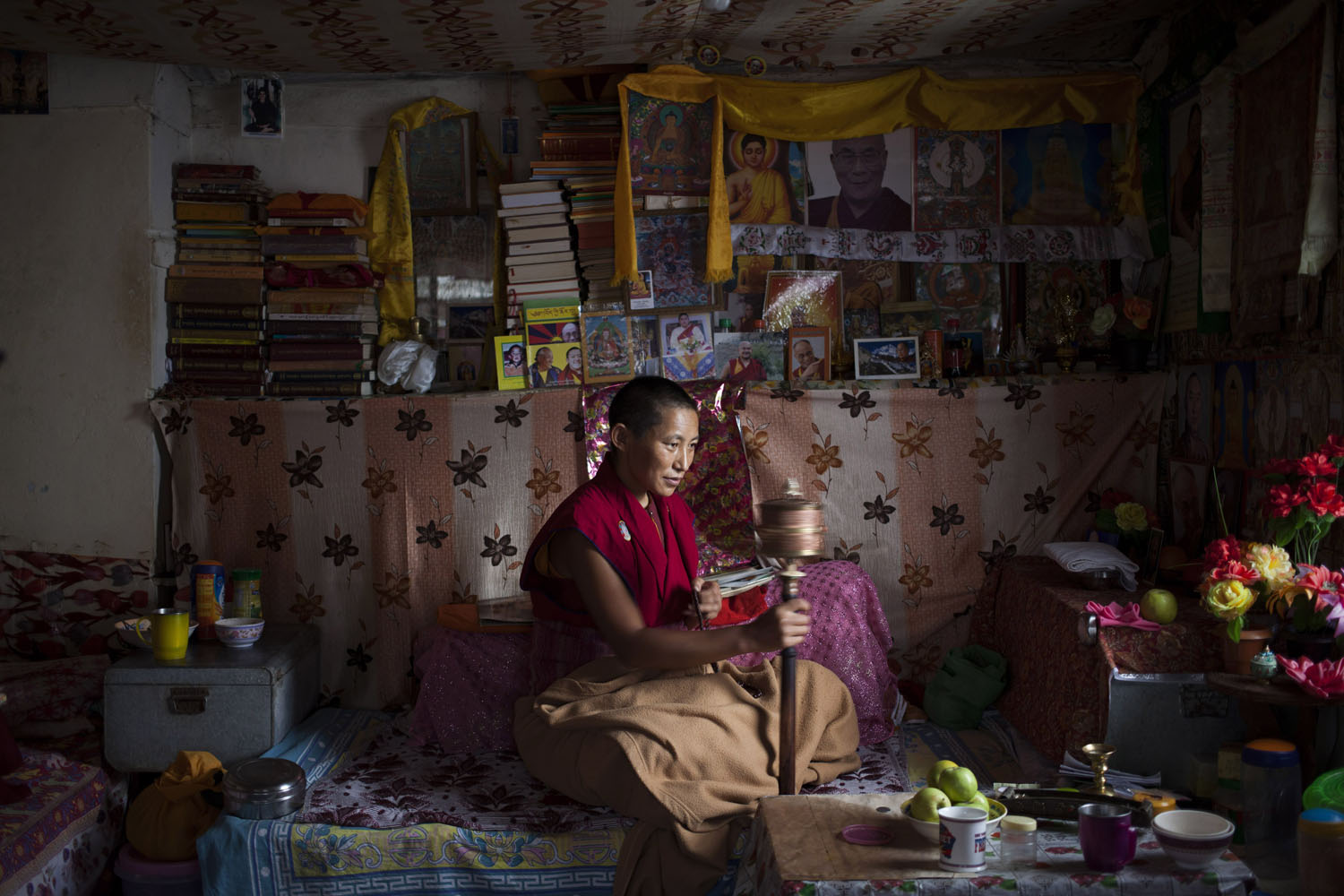An exile Tibetan nun Namdak Choeying, 44, prays in her room that she shares with two other nuns in Dharmsala, India. Back home in Tibet she aspired to be a fully ordained nun and escaped to India in 2006. Her five siblings and aged parents live in Tibet and she dreams about being reunited with them. Choeying said she immerses herself in prayers to keep her mind occupied. Sept. 27, 2014.