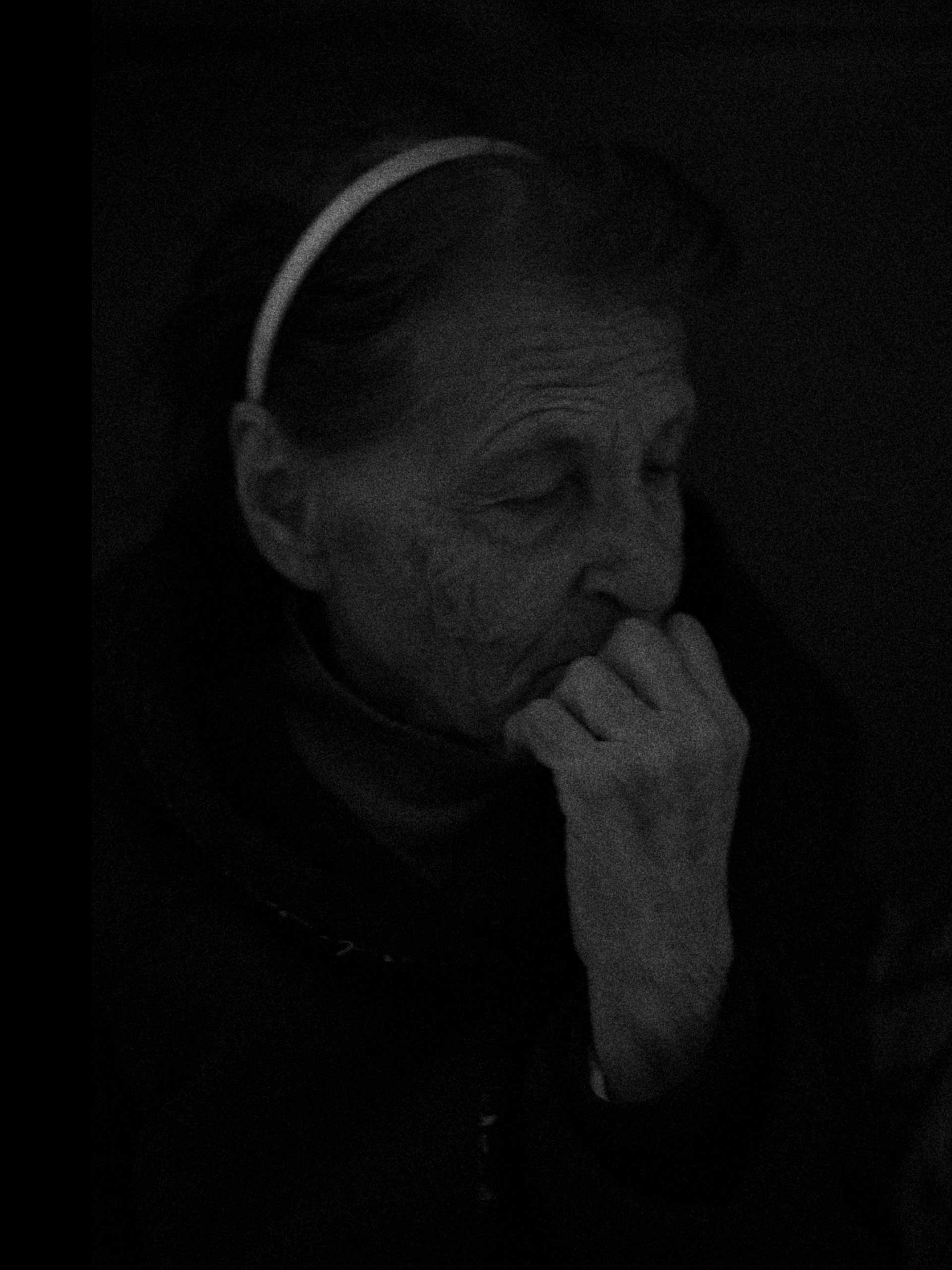 A portrait of Valentina is taken as we listened to shelling close to the shelter. The noise was actually the aftershock of a Tochka-U missile hitting a chemical plant some kilometers away sending a shockwave across much of the area. Donetsk, Kievski District, Ukraine. Oct. 20, 2014.