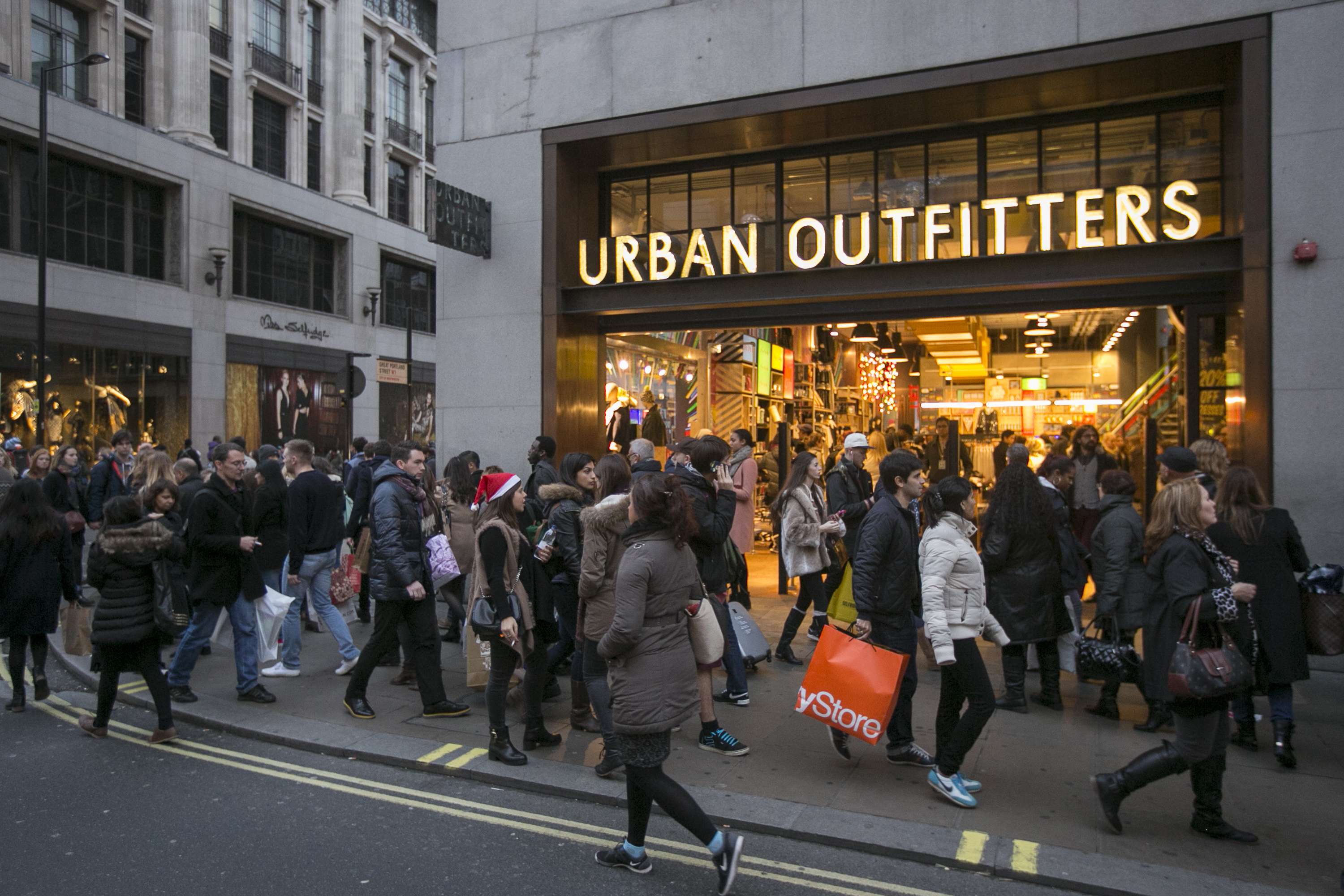 Shoppers walk outside Urban Outfitters on Dec. 14, 2013 in London.